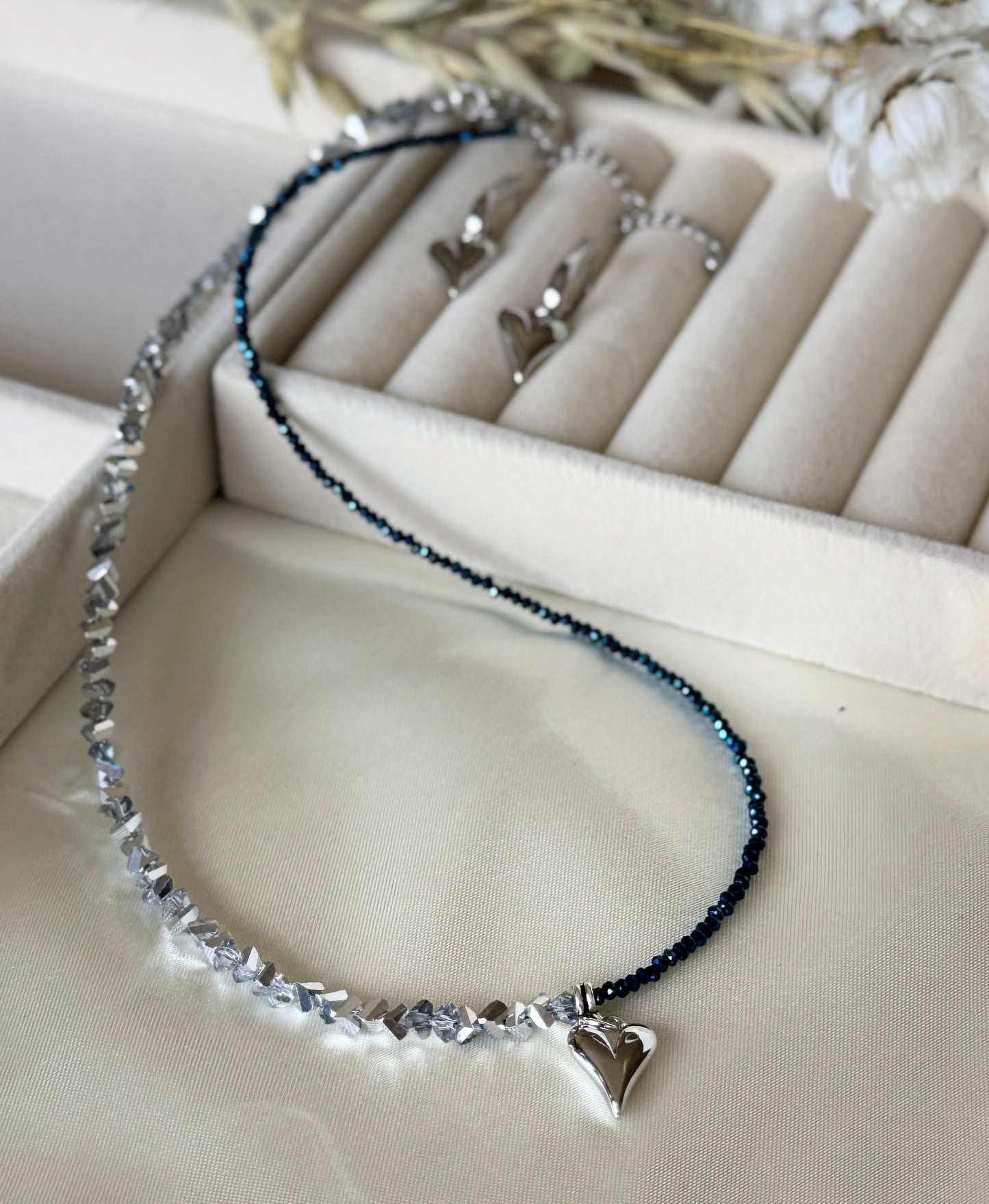 Hematite and silver crystal necklace and earrings set on white background