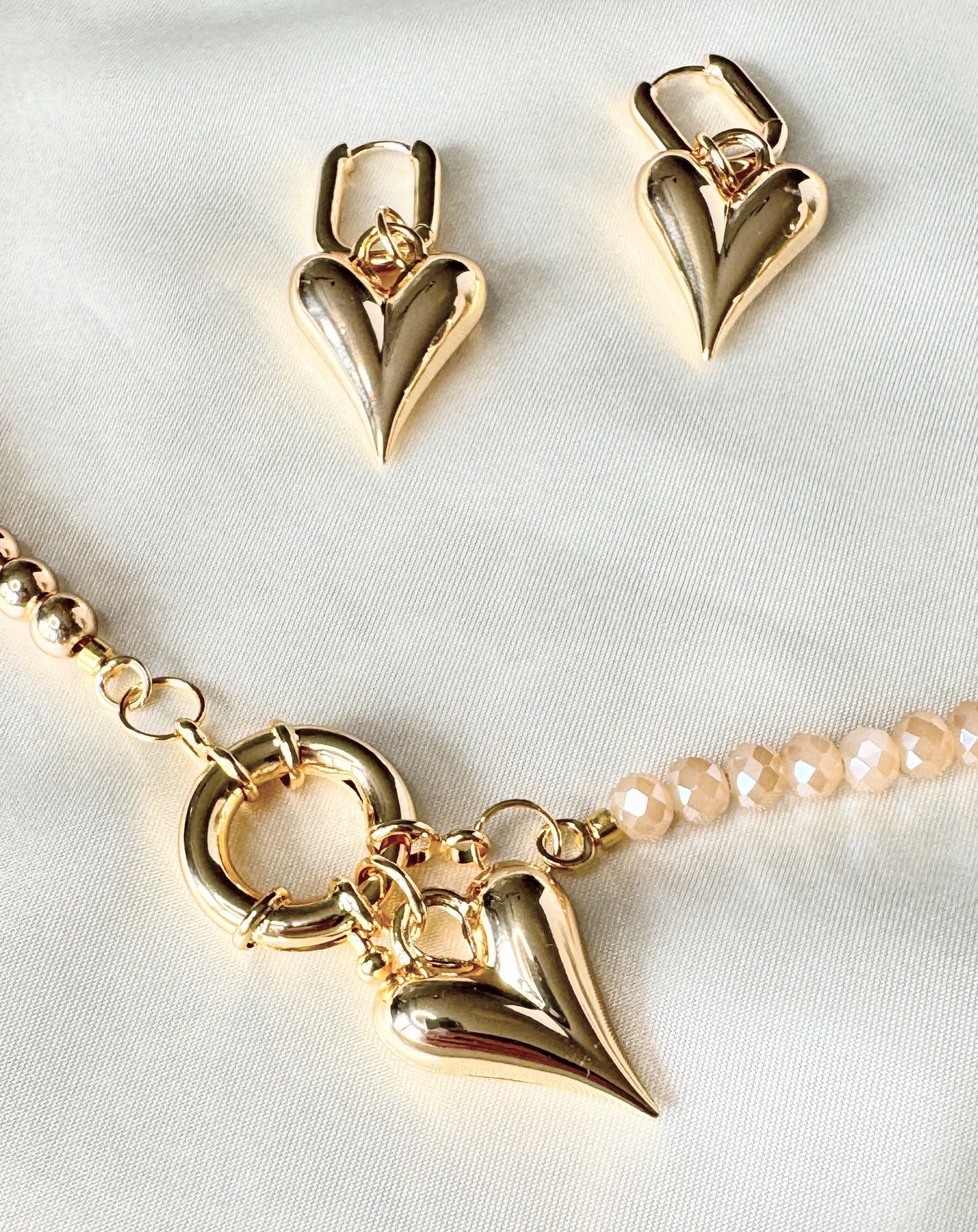 Close-up of hematite golden crystal necklace with dangling earrings