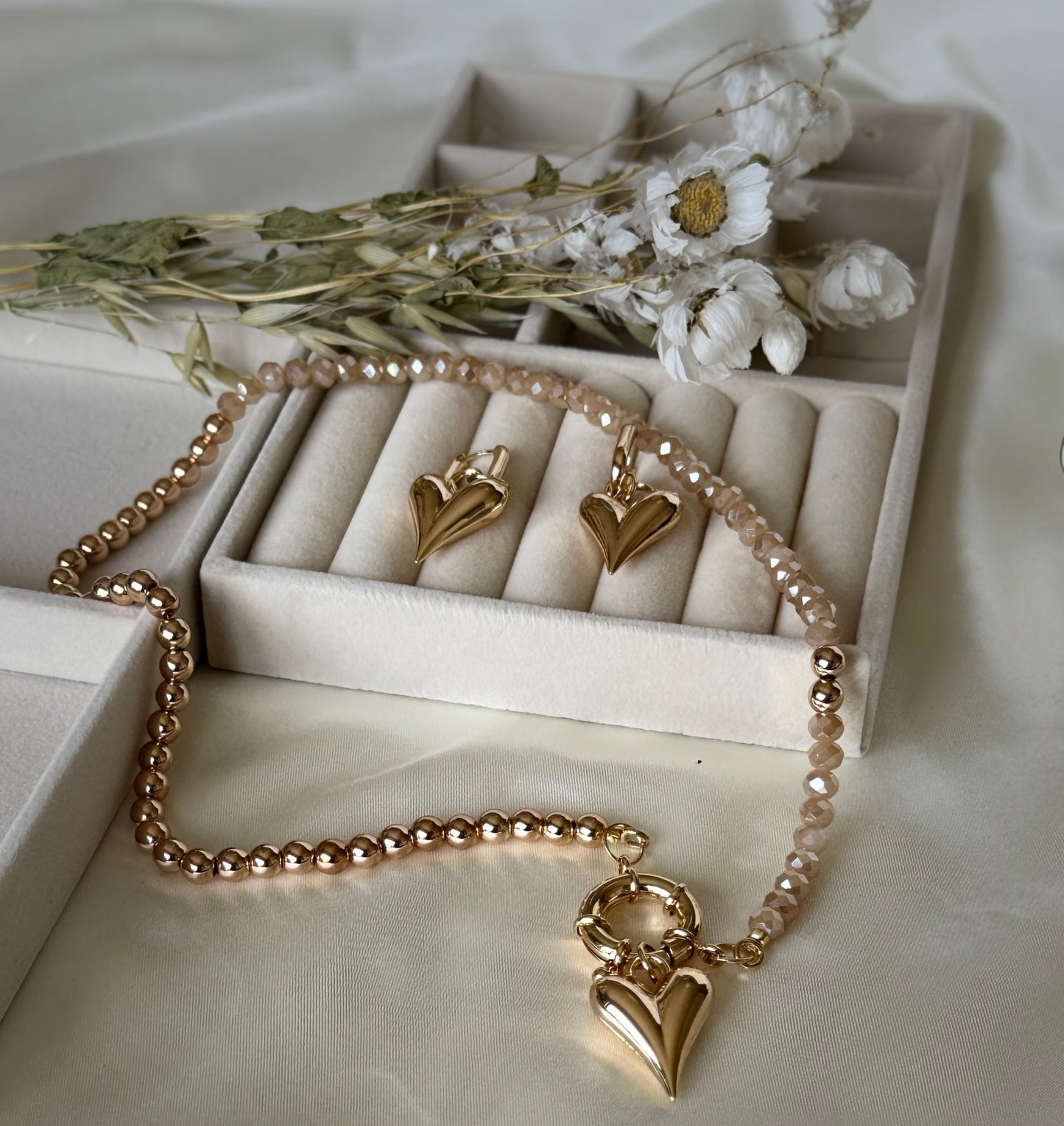 Layered hematite and golden crystal necklace paired with matching earrings