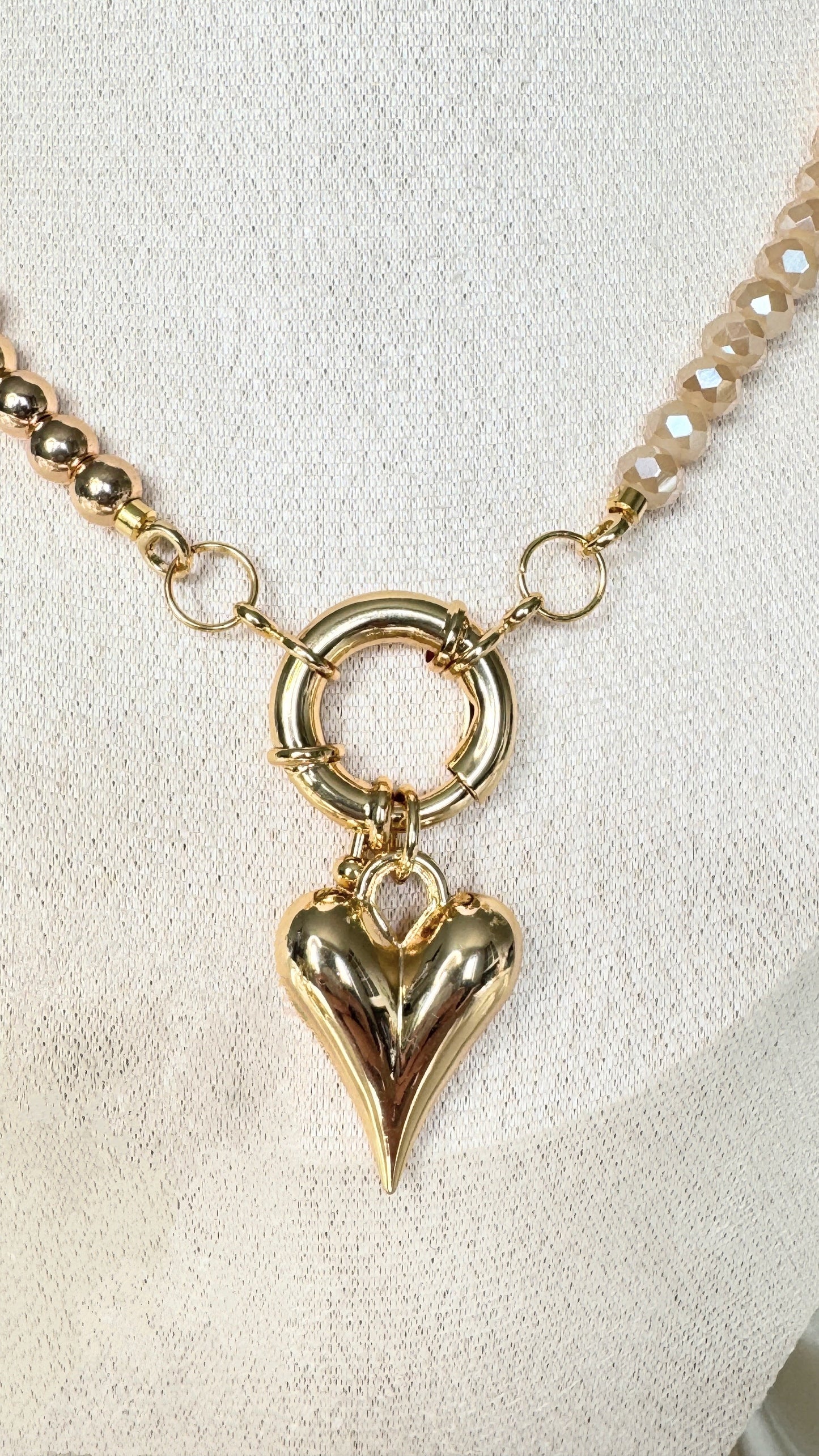Close-up of golden crystal heart pendant with hematite crystals on necklace - second variant