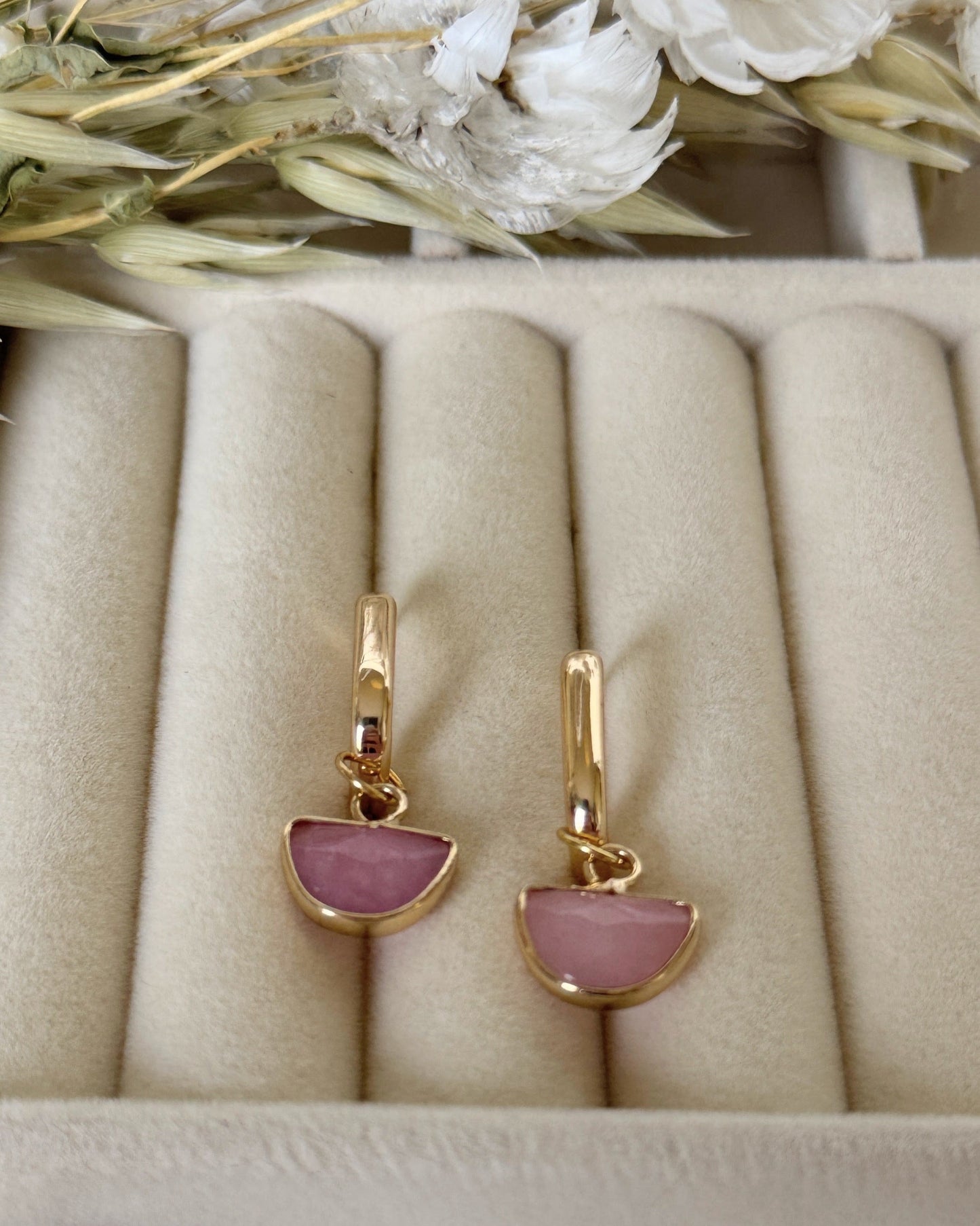 Close-up of dangling light pink hematite and pearl earrings