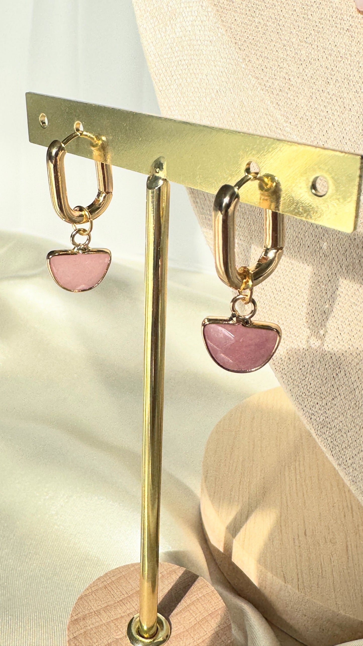 Elegant pink hematite and pearl earrings displayed on jewelry tray