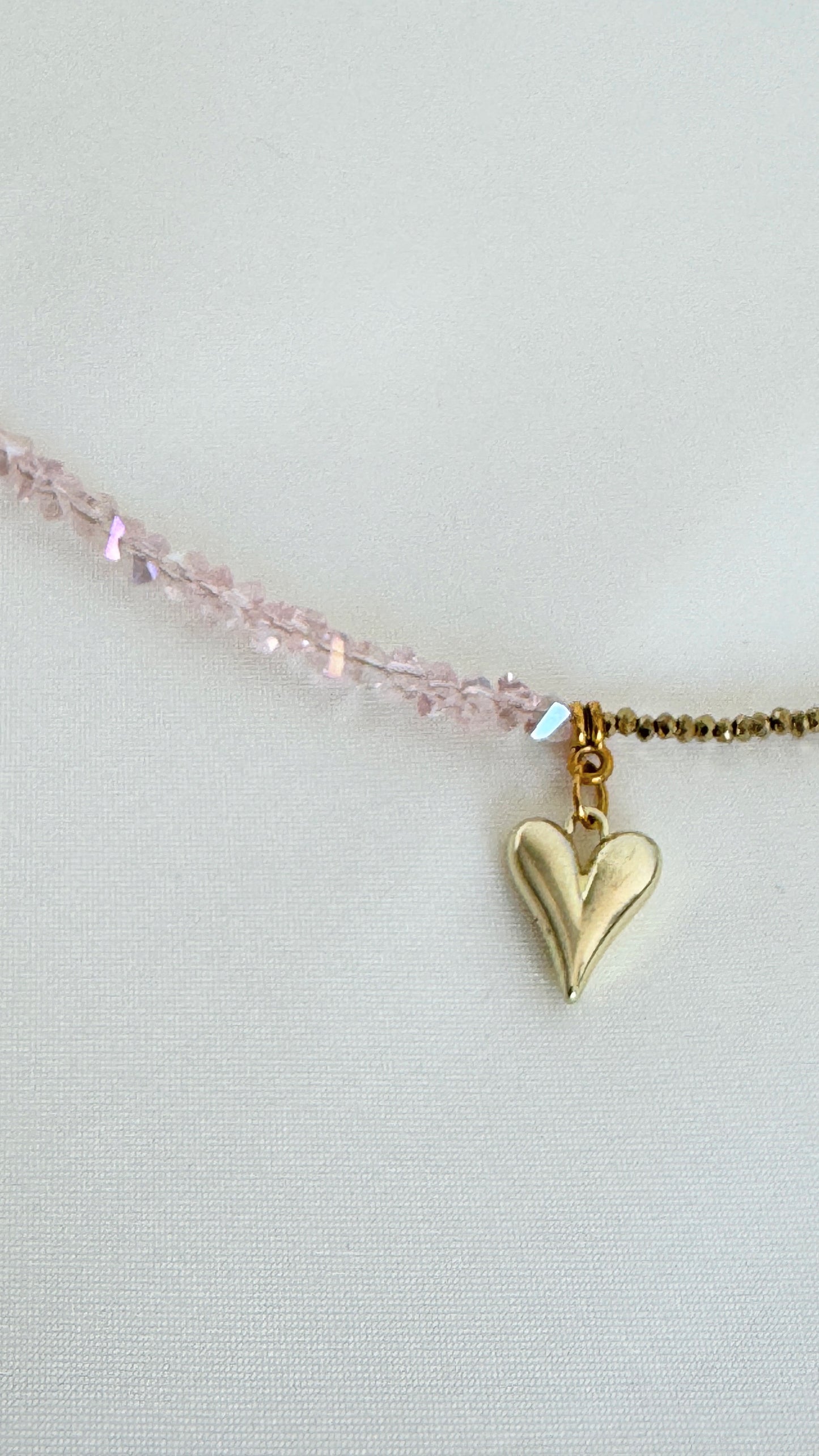 Refined necklace featuring pink crystal beads and delicate gold spacers