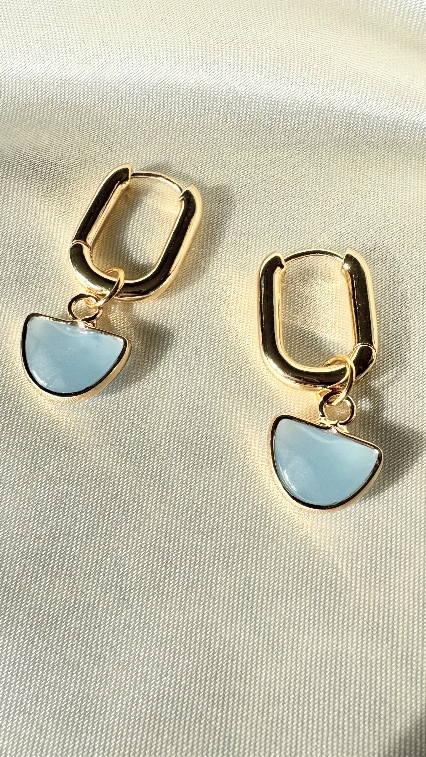 Close-up of blue hematite crystal earrings with gold accents