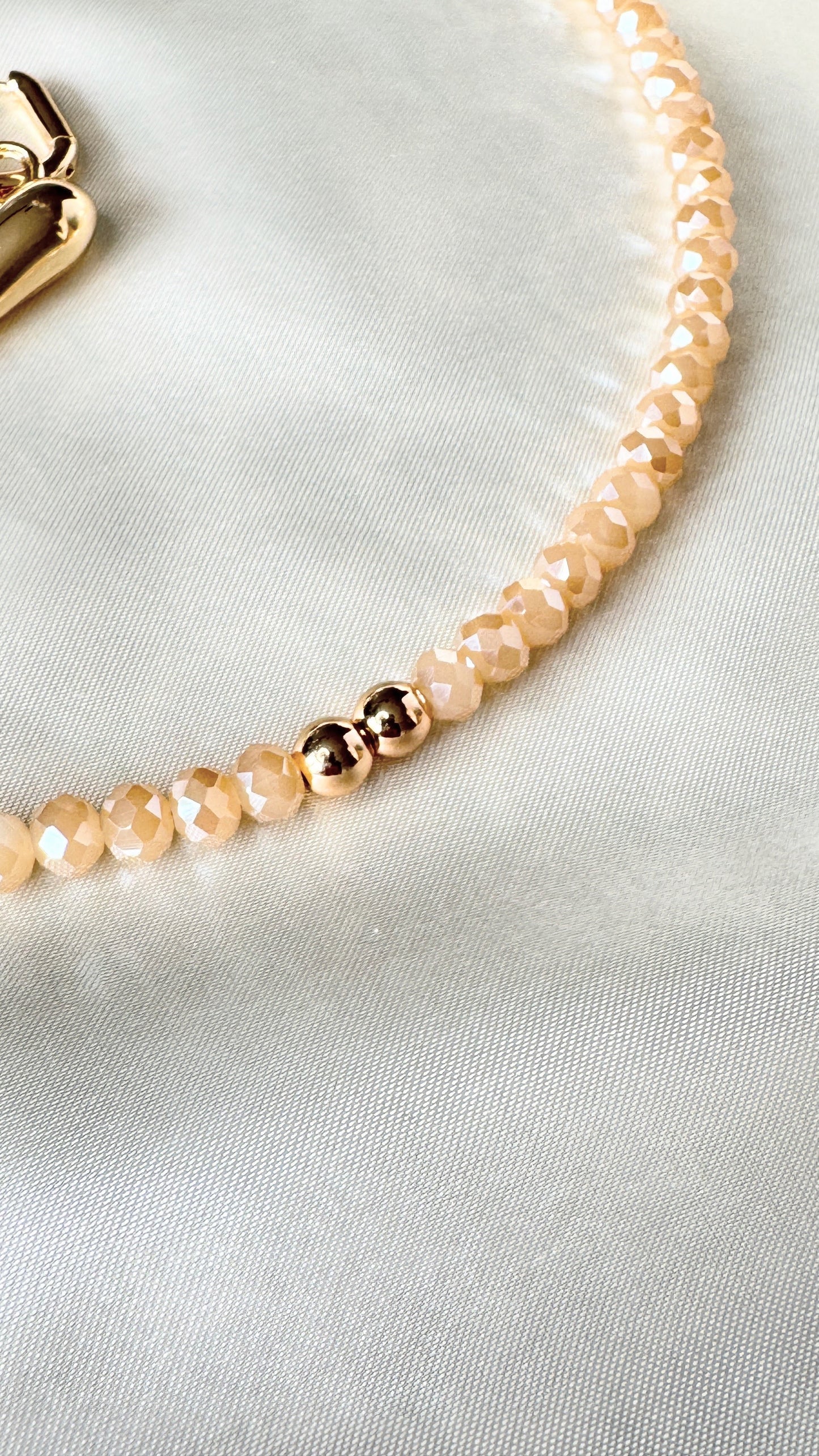 Close-up of golden crystal necklace with hematite crystals