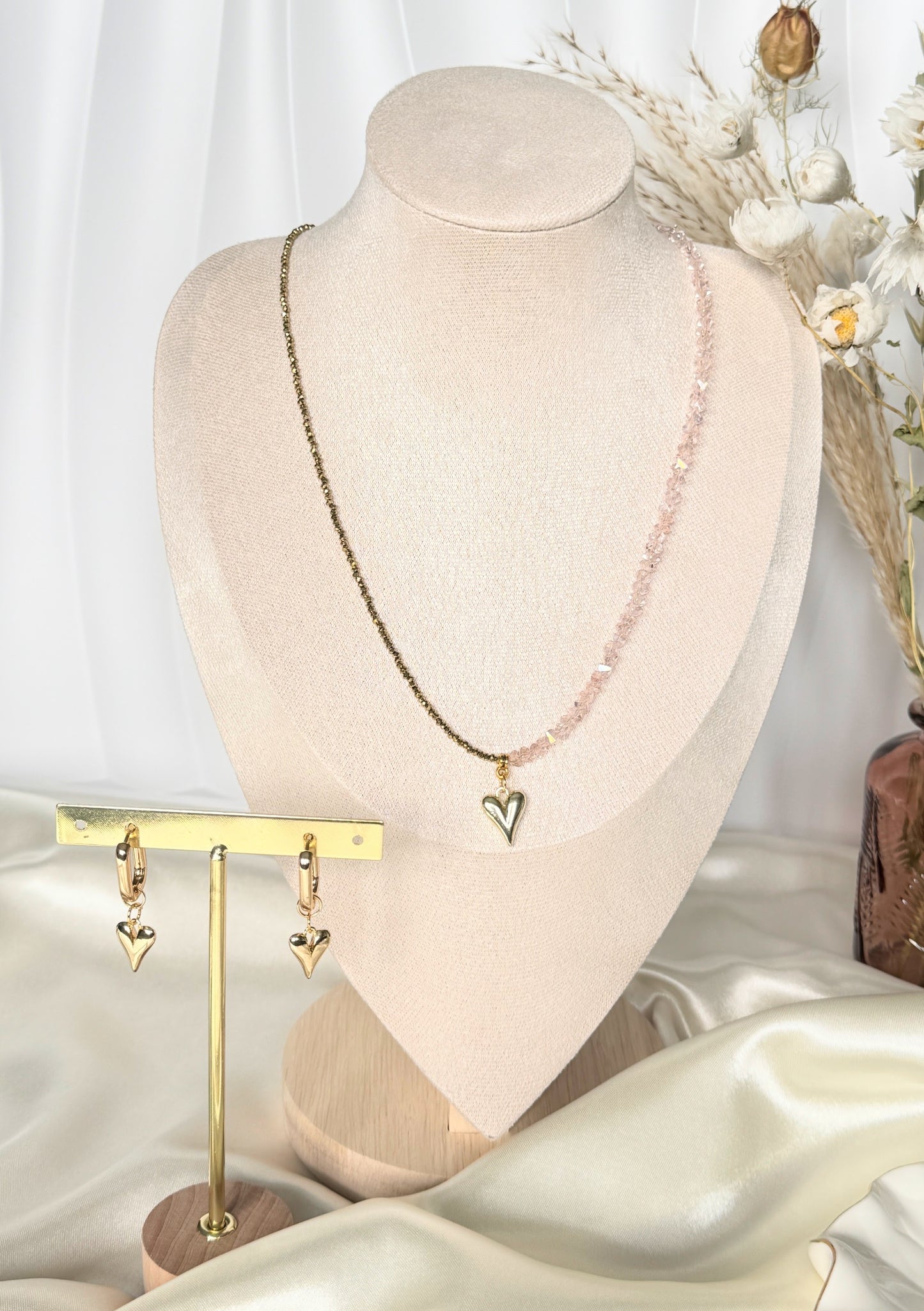 Close-up of pink gold hematite crystal necklace and earrings set