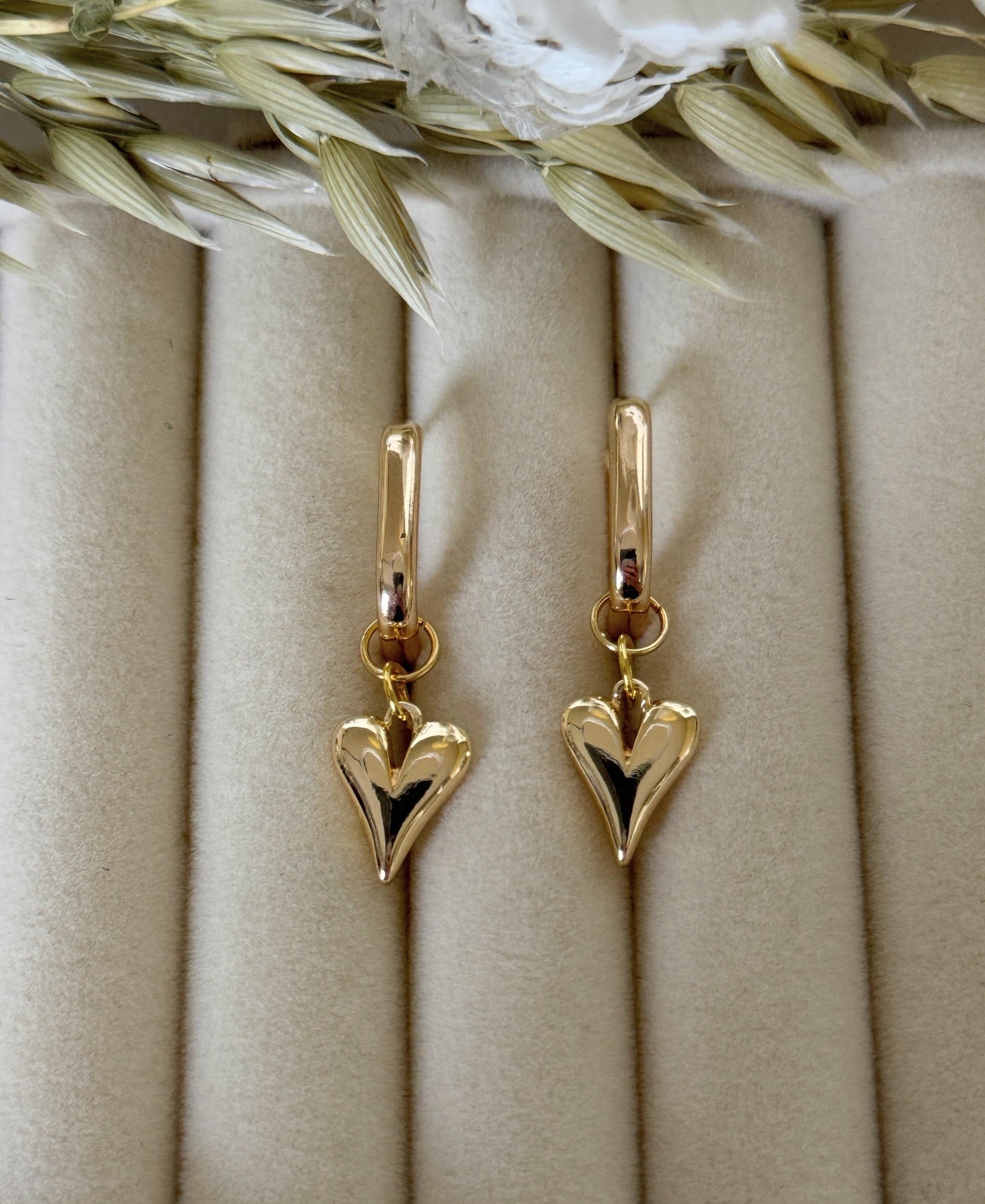 Pink gold hematite and crystal earrings on fabric background