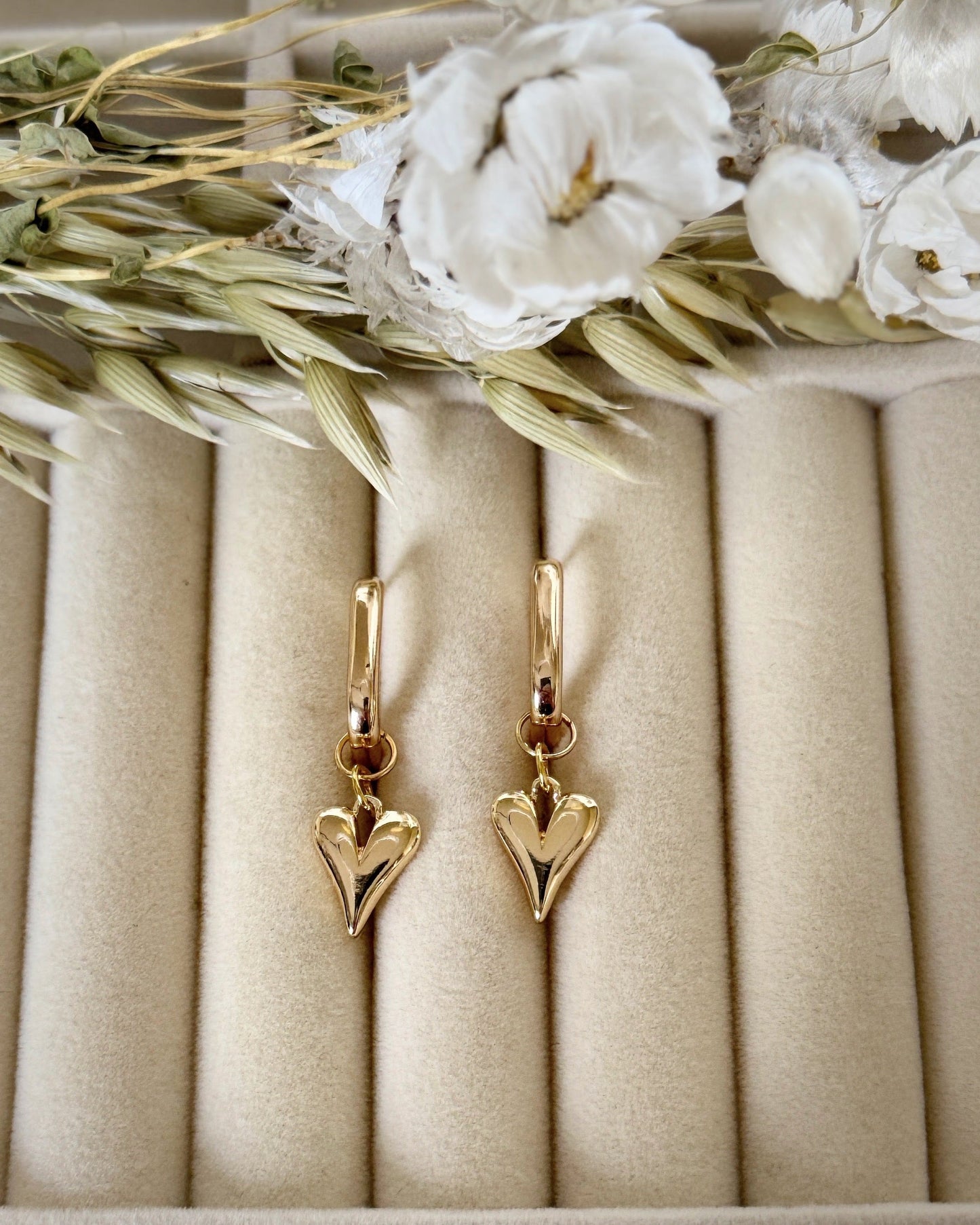 Close-up of pink gold hematite crystal earrings with dangling design