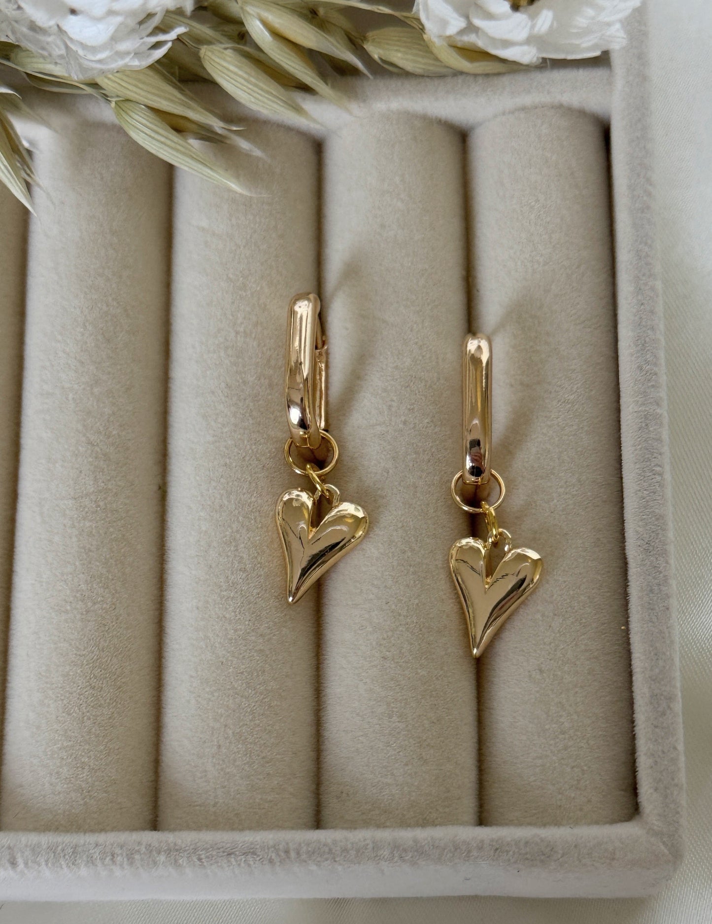 Elegant pink gold hematite crystal earrings displayed on jewelry tray