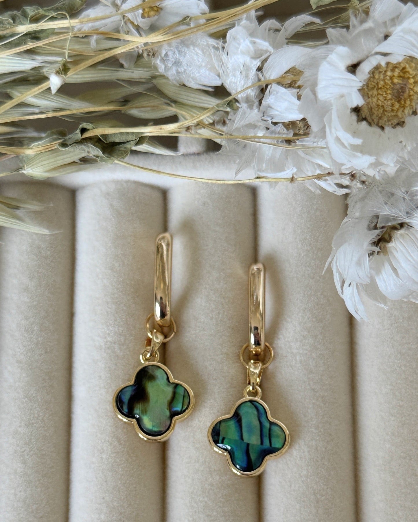Elegant lucky clover hematite earrings displayed on jewelry tray