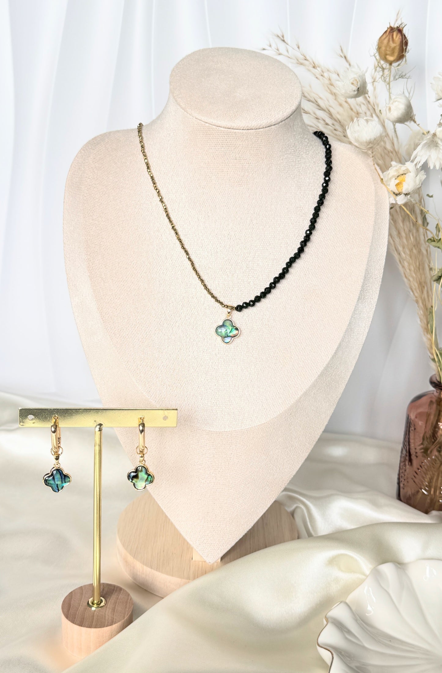 Lucky clover hematite crystal necklace and earrings set displayed on tray