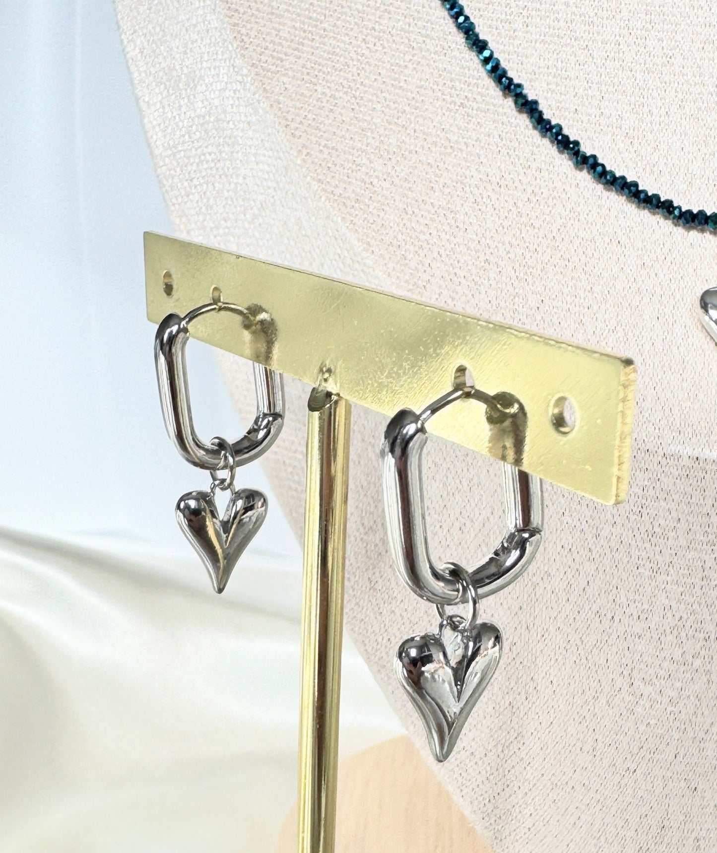 Close-up of silver heart earrings with hematite crystal beads