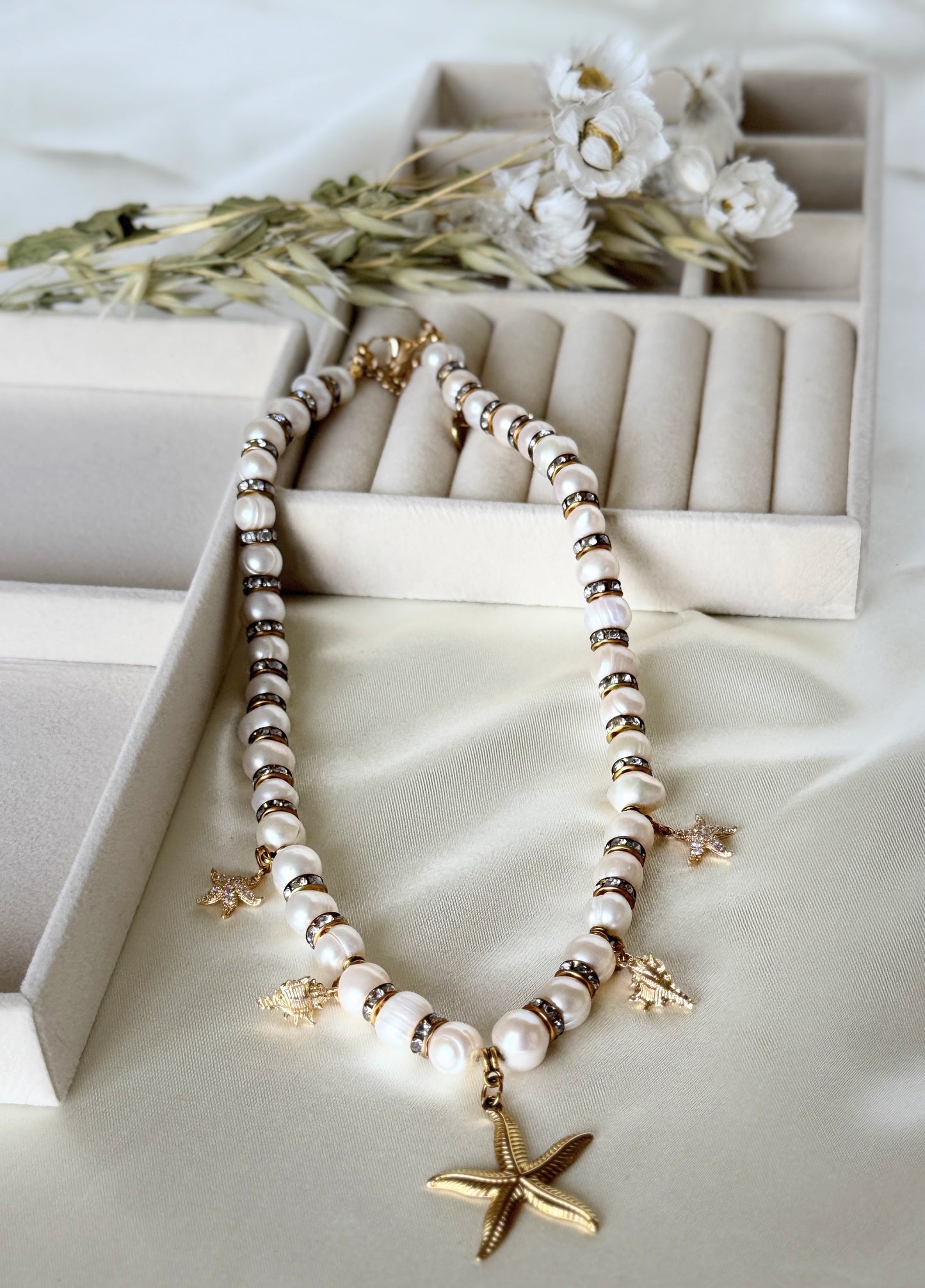 Elegant golden sea pearl necklace displayed on soft fabric