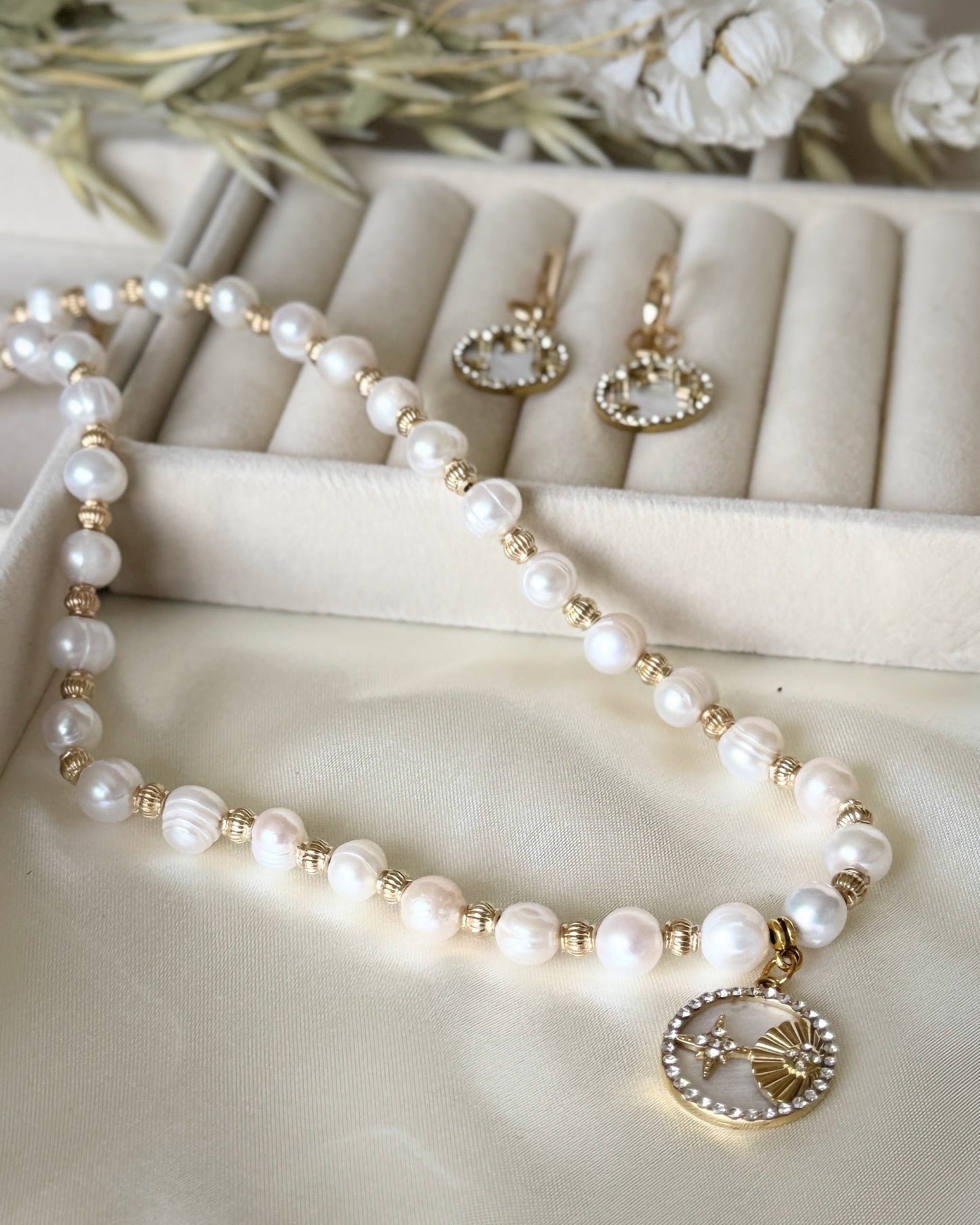 Premium mother-of-pearl beaded necklace with gold shell pendant on white background