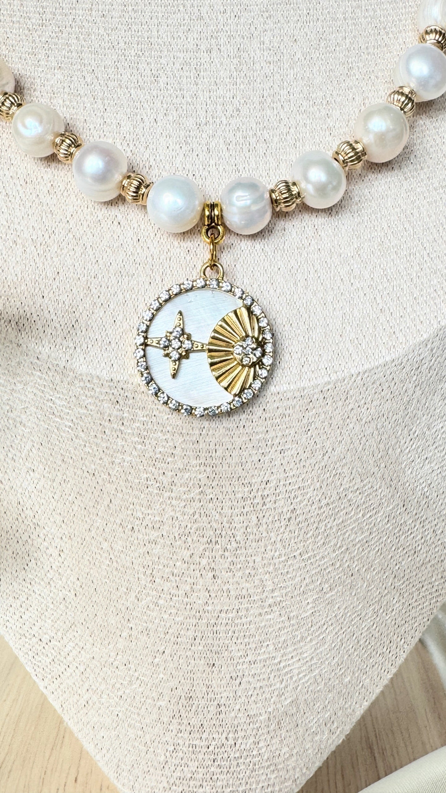 Close-up of luxurious mother-of-pearl beads with gold accents on necklace