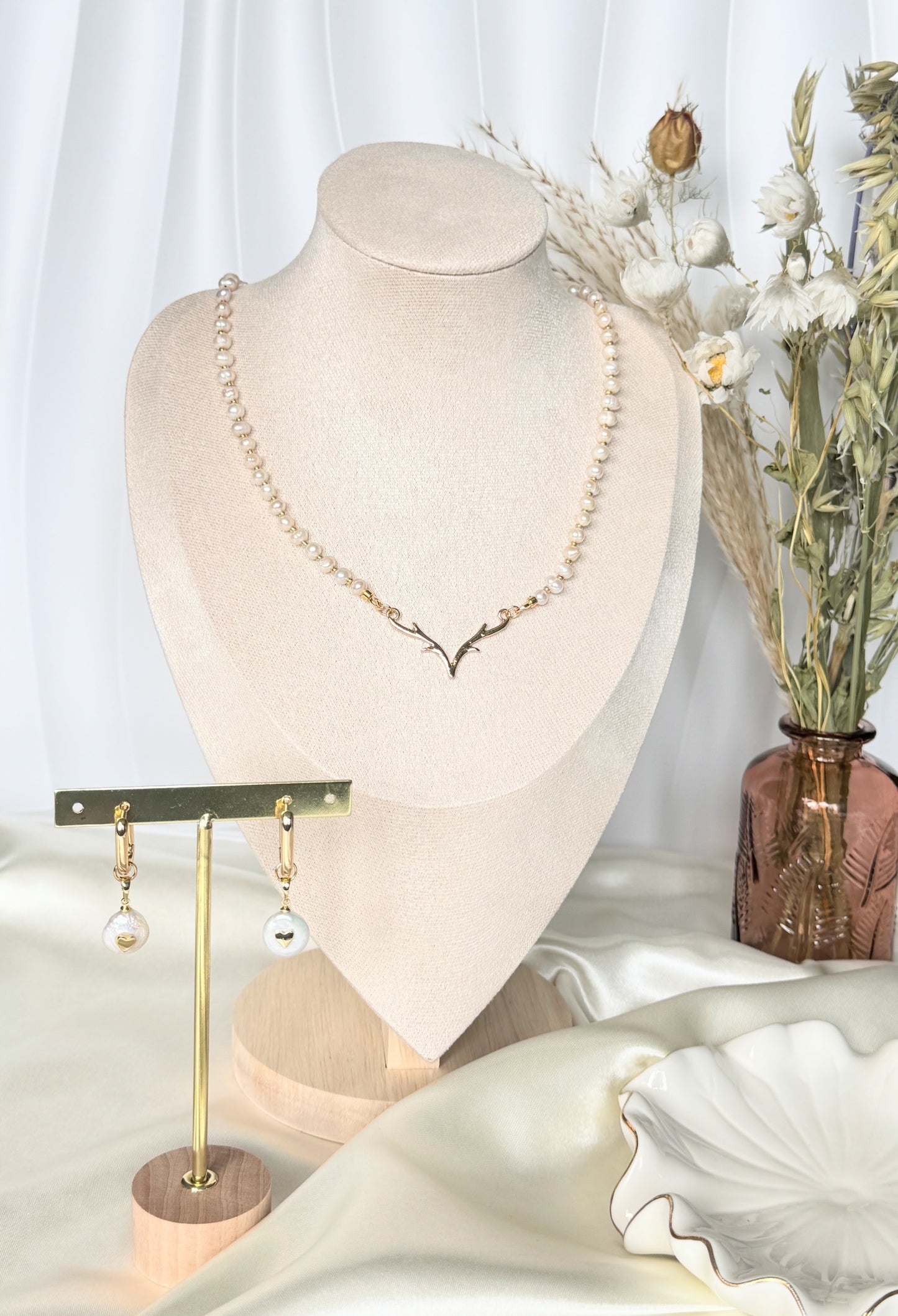 Close-up of deer antler pearl necklace and earrings jewelry set