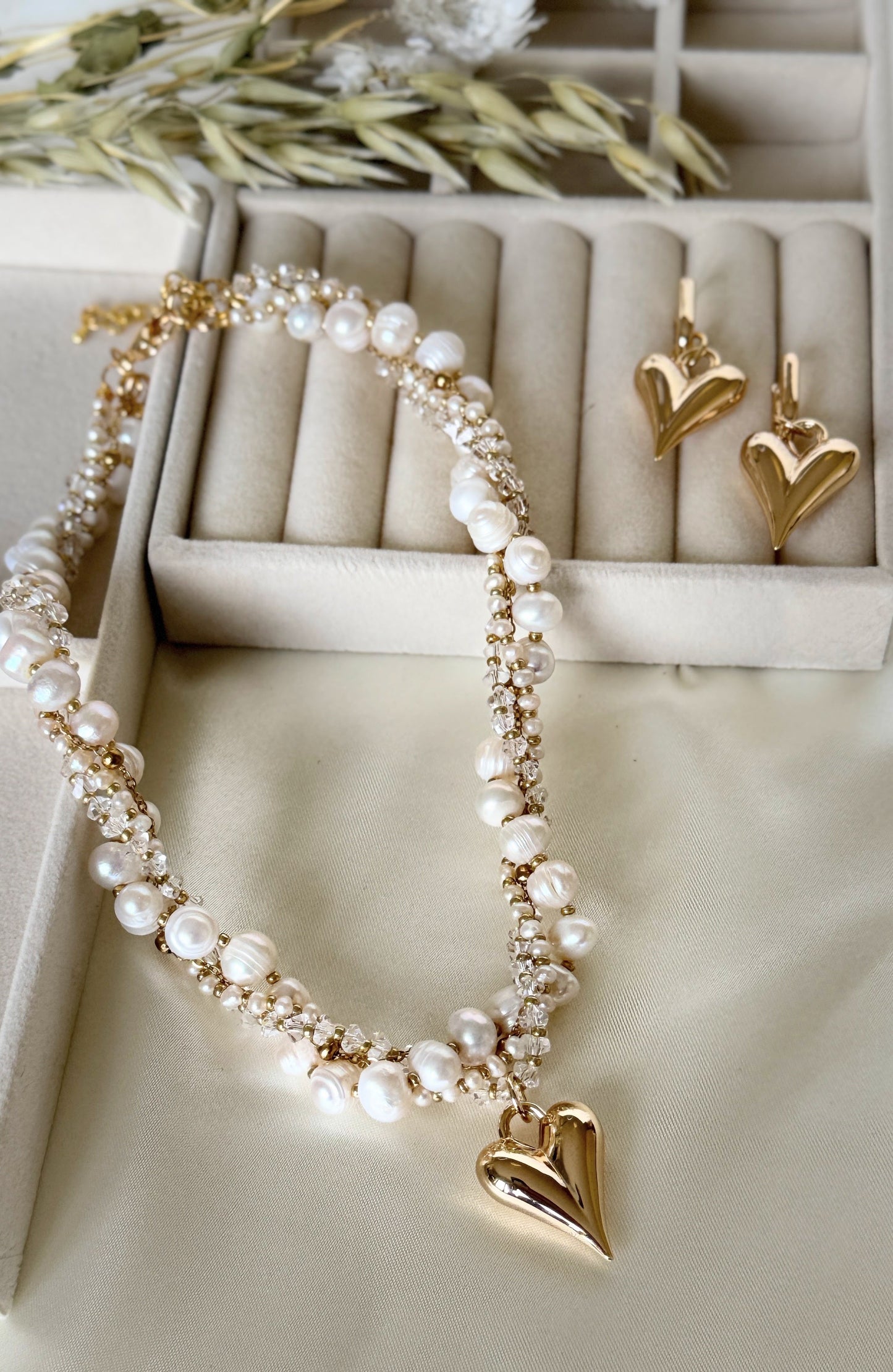 Close-up of layered pearl crystal necklace with matching earrings