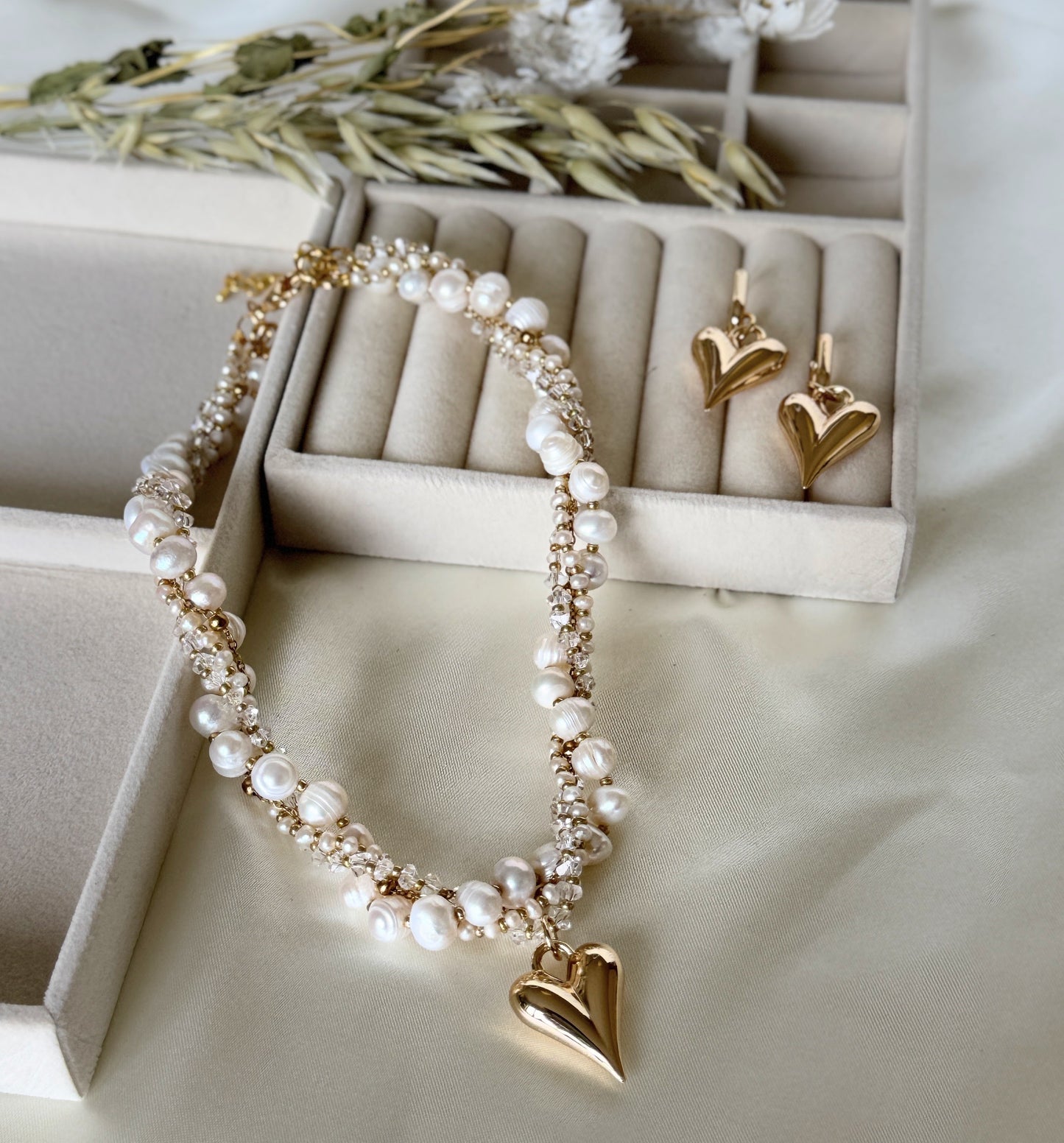 Elegant layered pearl and crystal necklace paired with earrings
