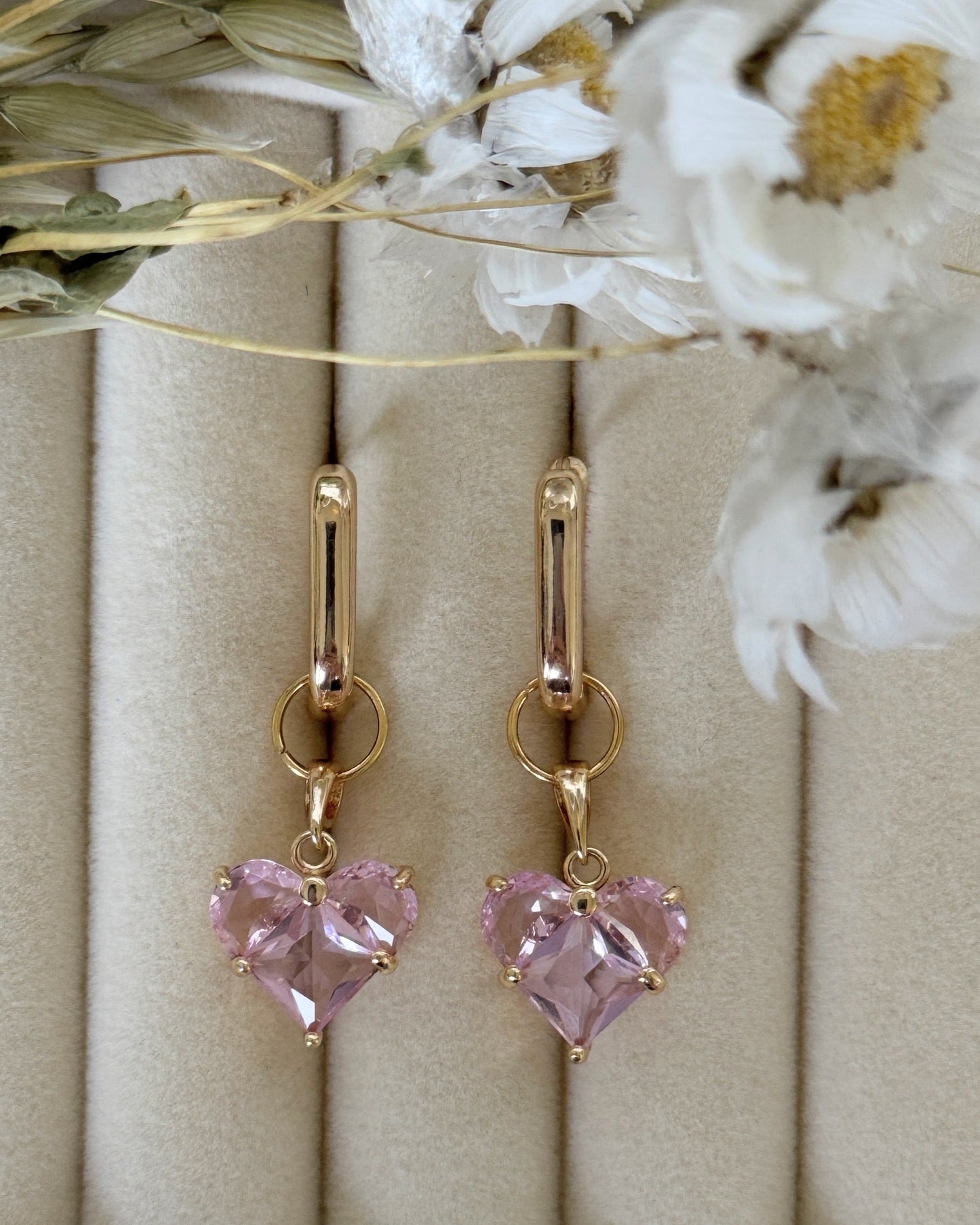 Close-up of pink crystal pearl earrings with delicate gold accents