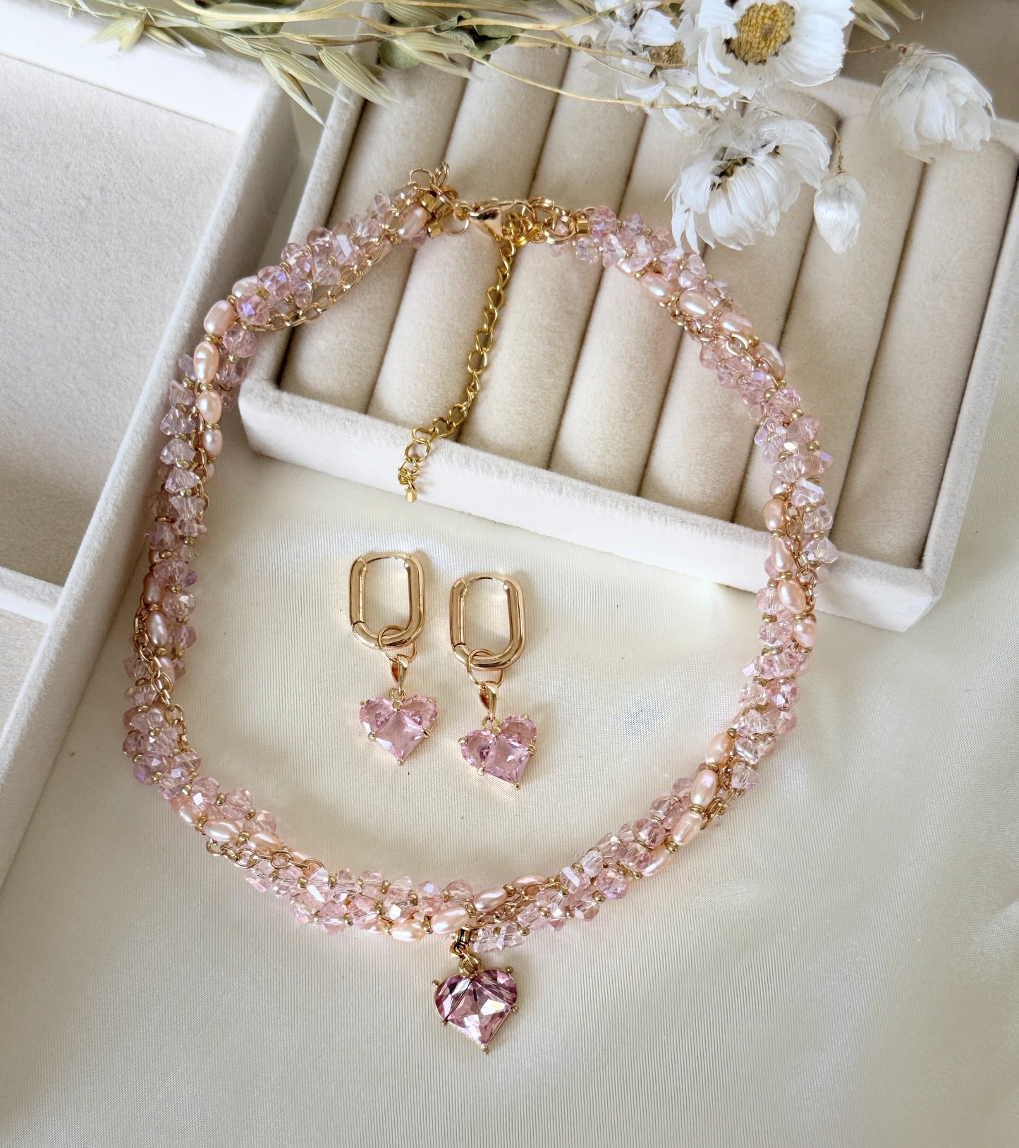 Pink layered crystal pearl necklace and matching earrings set with gold accents