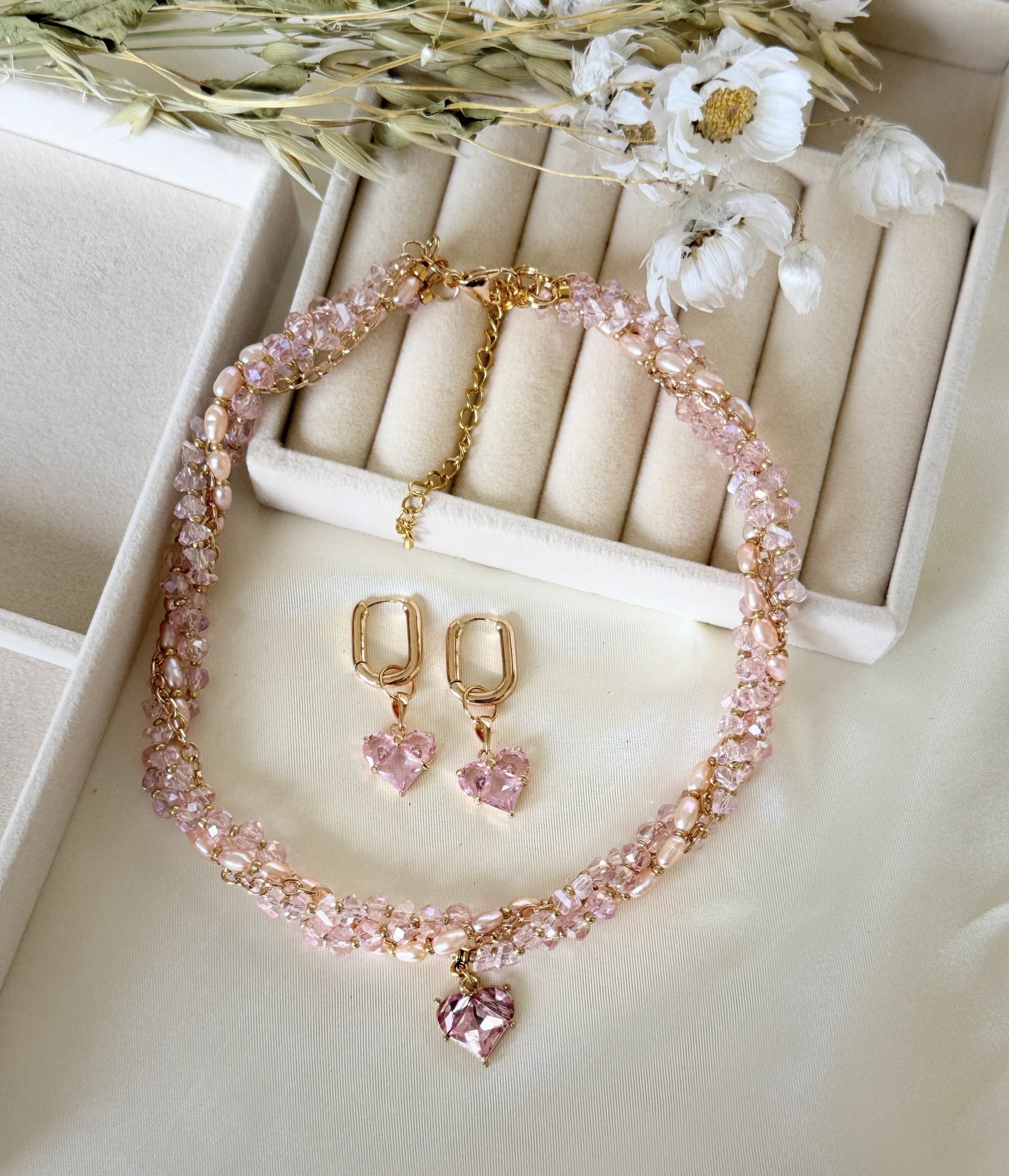 Jewelry set with pink crystal pearl necklace and dangling earrings on white background - second variant