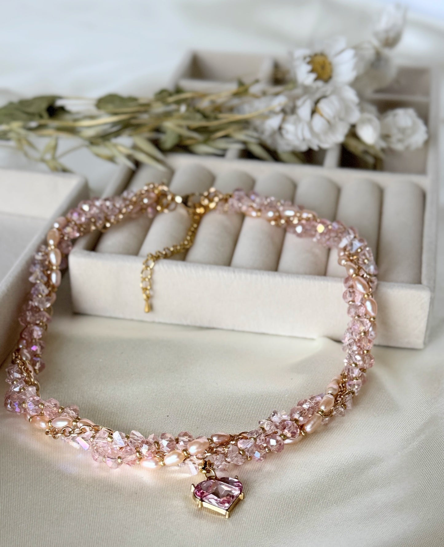 Detail shot of freshwater pearls on pink layered necklace