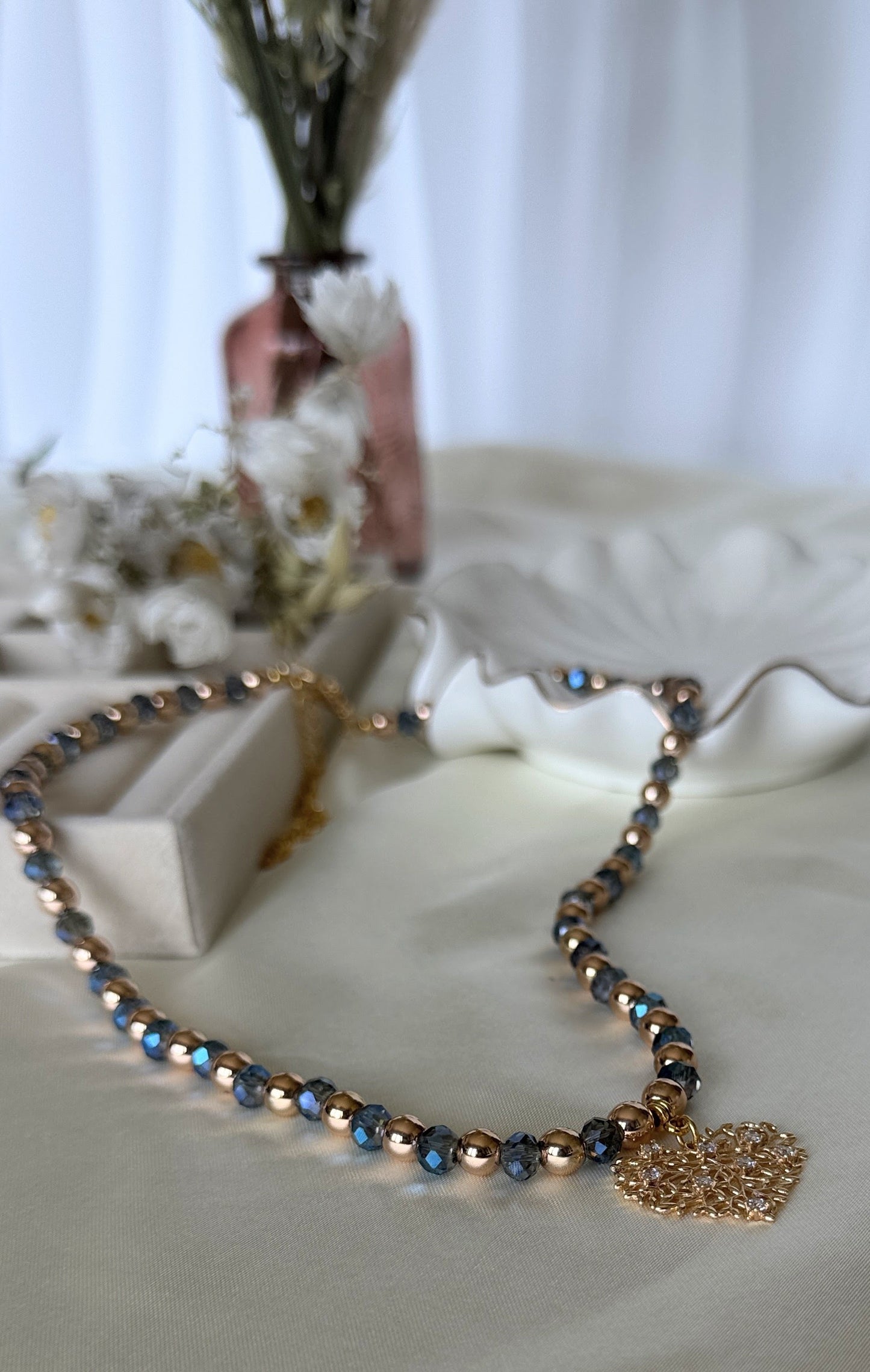 Adjustable clasp of tree blue crystal hematite necklace with gold accents