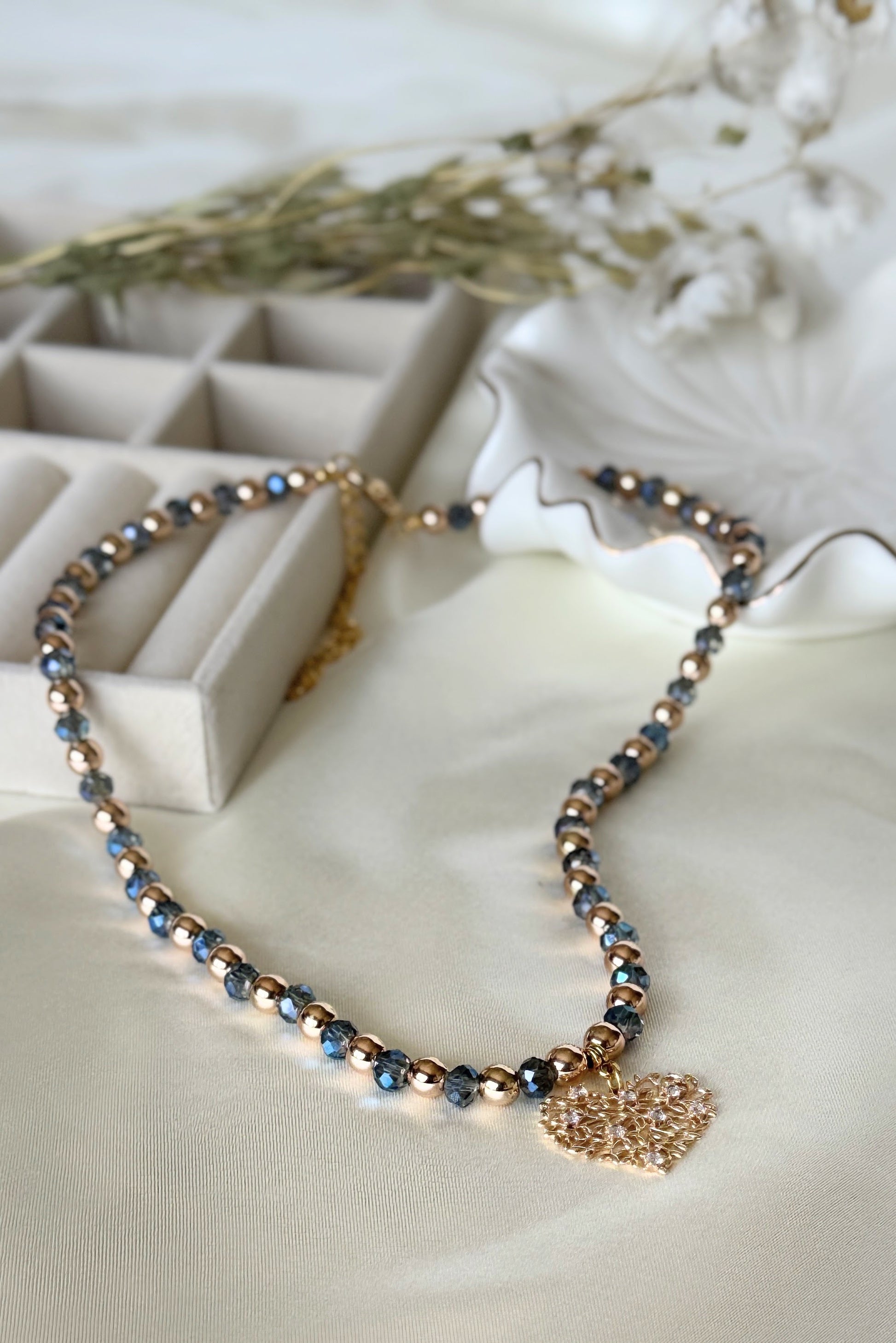 Layered blue crystal and hematite necklace with tree of life pendant