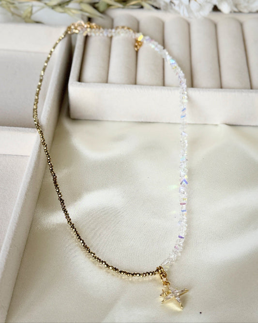 Stars hematite crystal necklace with layered gold chains on white background