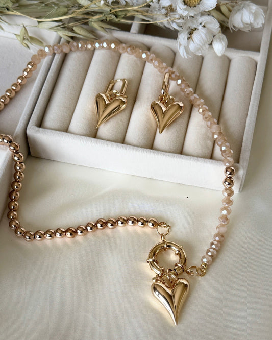 Elegant golden crystal heart jewelry set with hematite accents displayed together