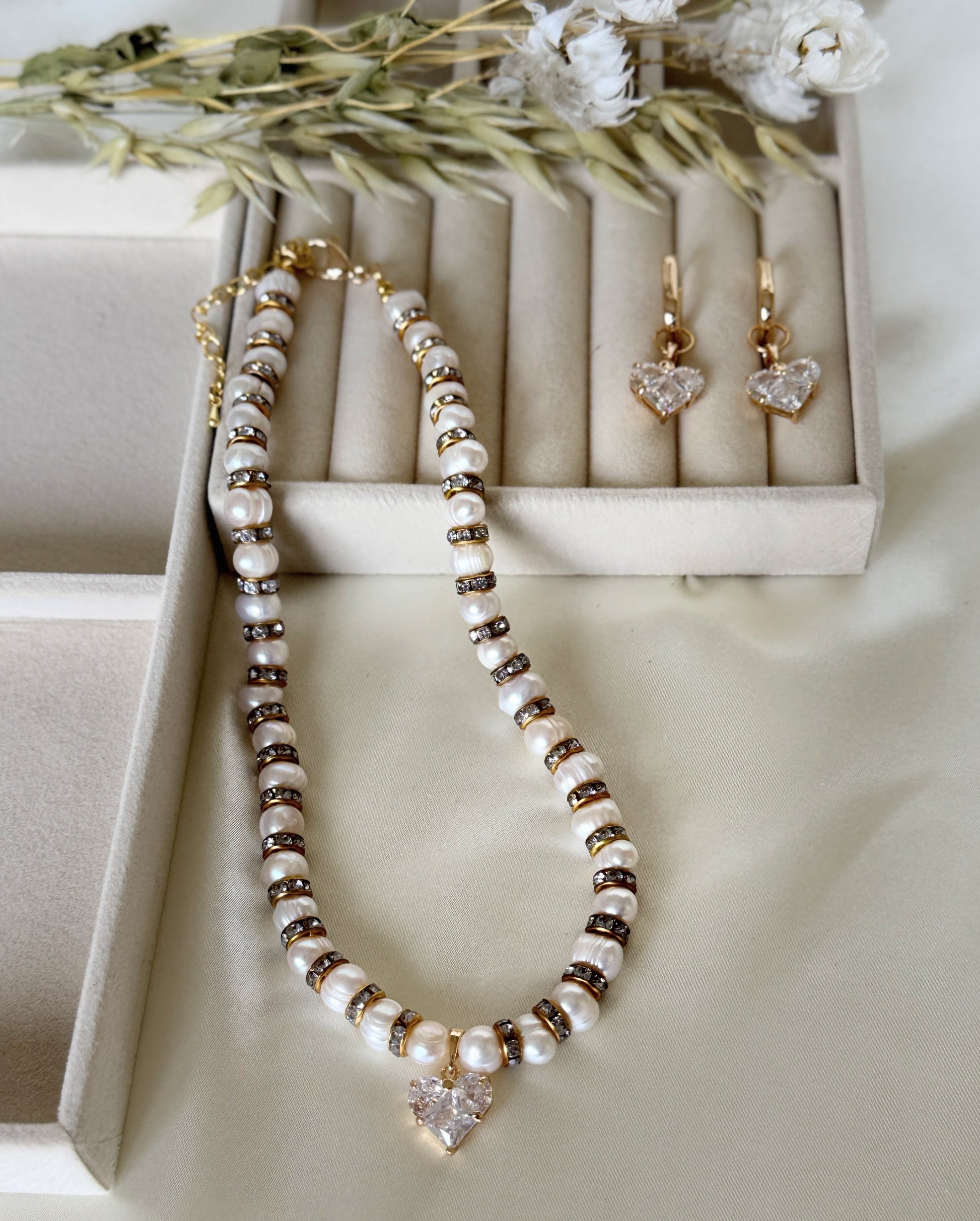 Elegant pearl necklace with crystal heart pendant and matching earrings
