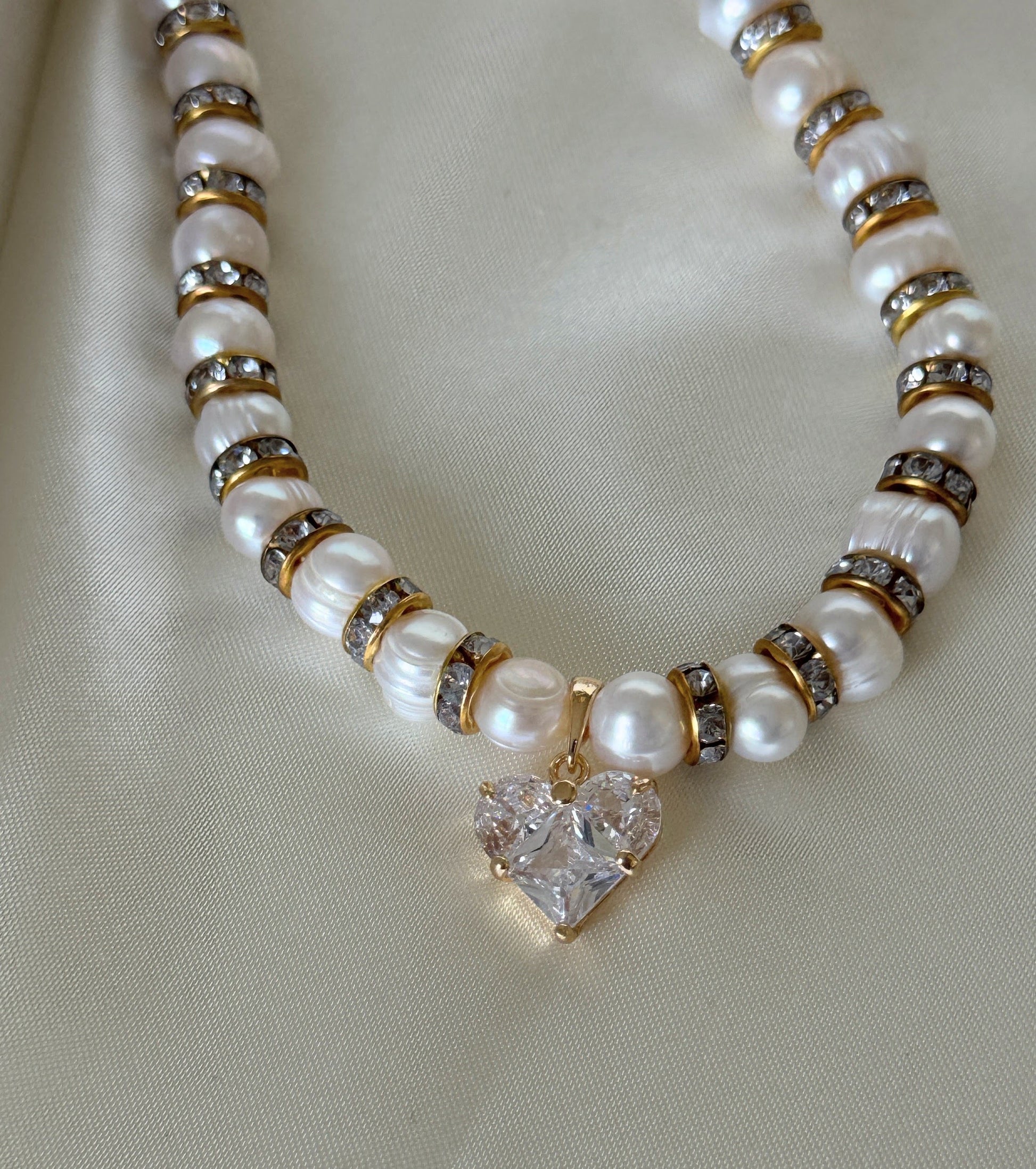 Close-up of crystal heart pendant on freshwater pearl necklace