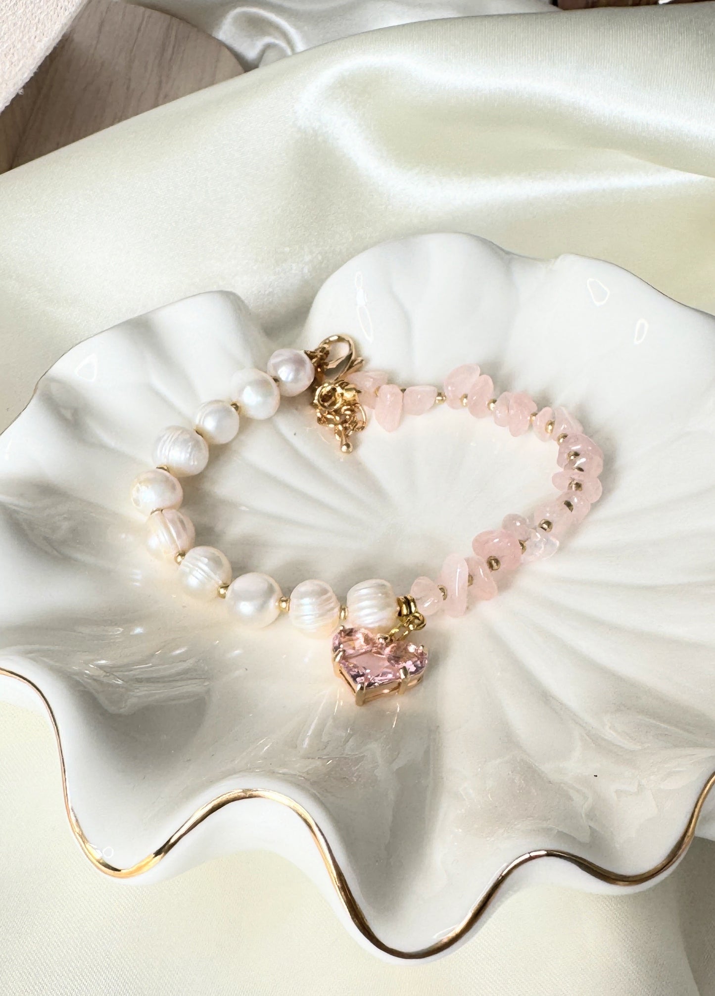 Close-up of freshwater pearl and pink quartz bracelet with gold details