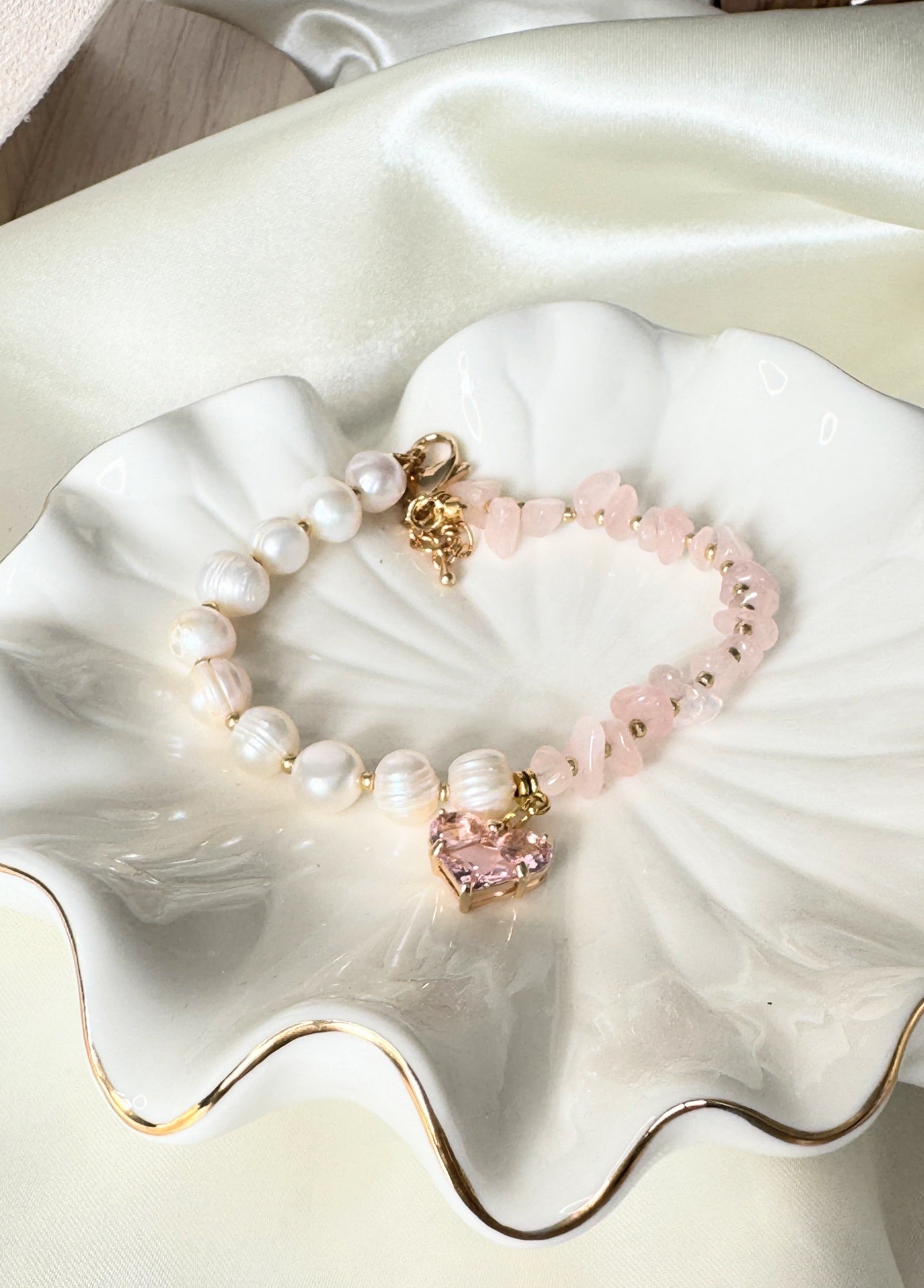 Close-up of freshwater pearl and pink quartz bracelet with gold details