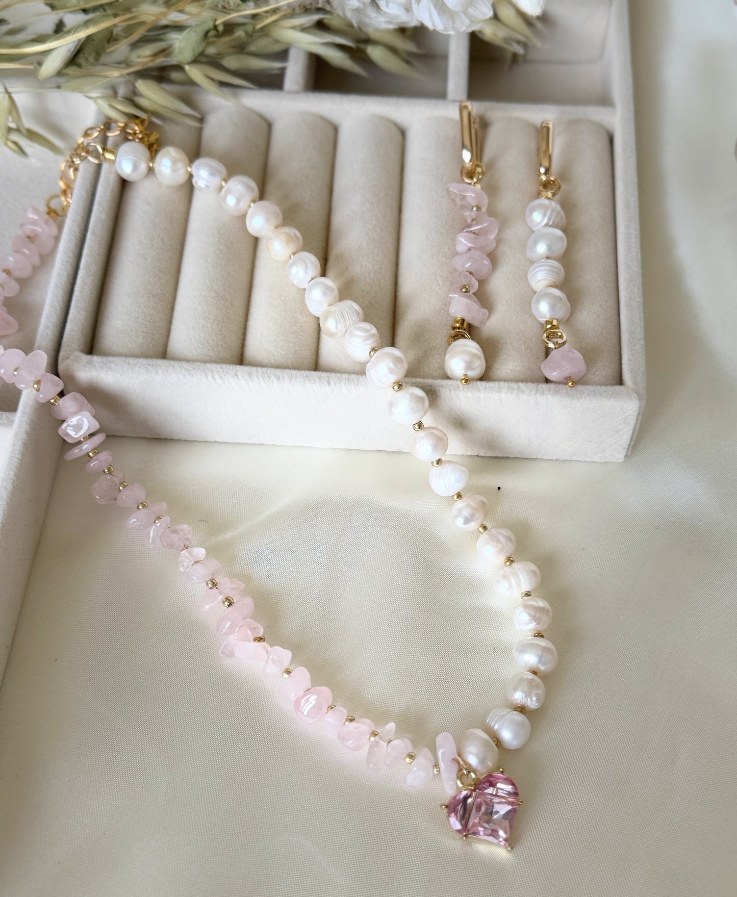 Elegant pink quartz beaded necklace paired with matching pearl earrings