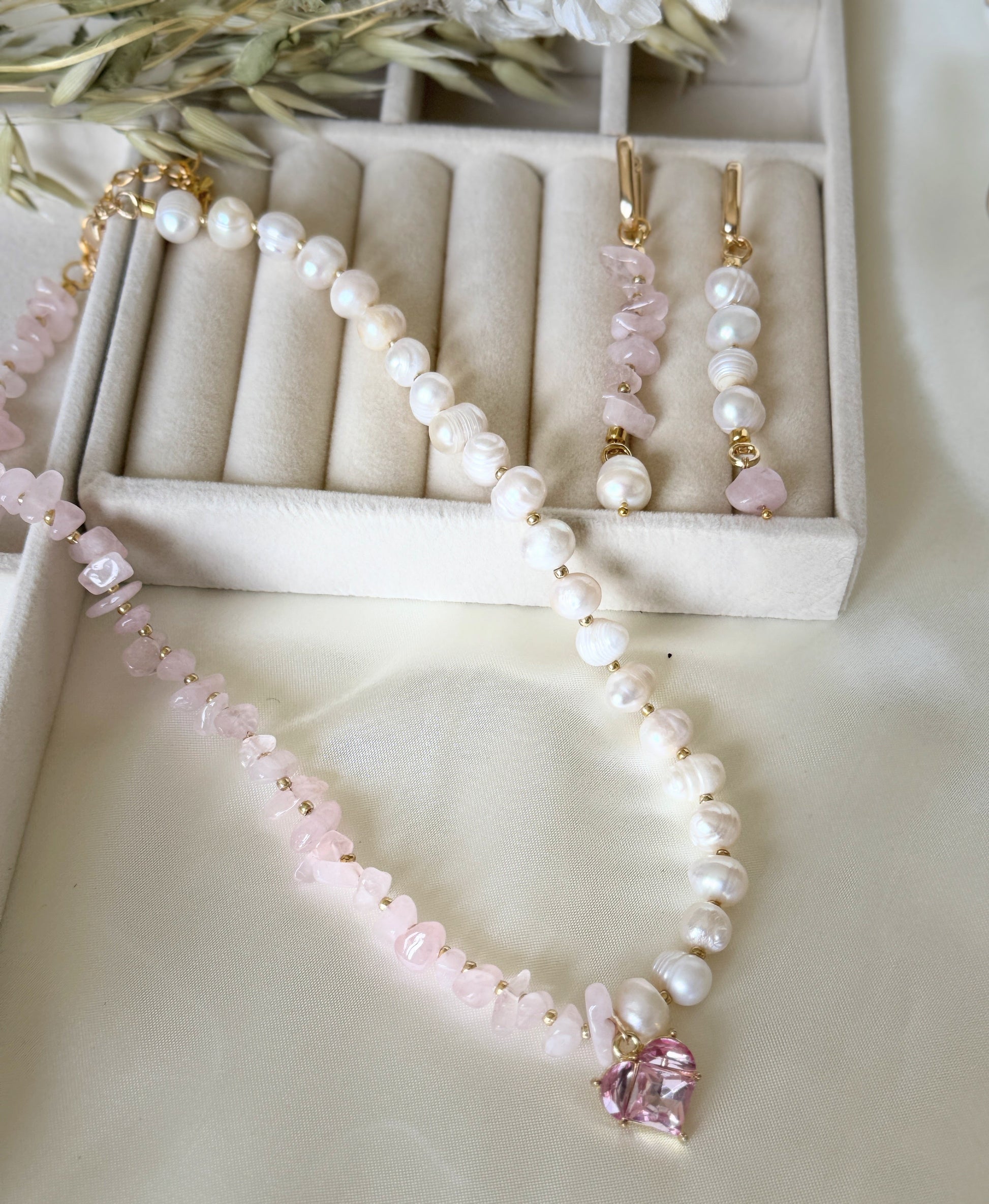 Elegant pink quartz beaded necklace paired with matching pearl earrings