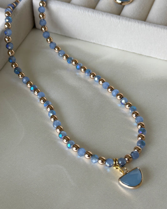 Blue gold hematite crystal necklace with layered gold chains on white background