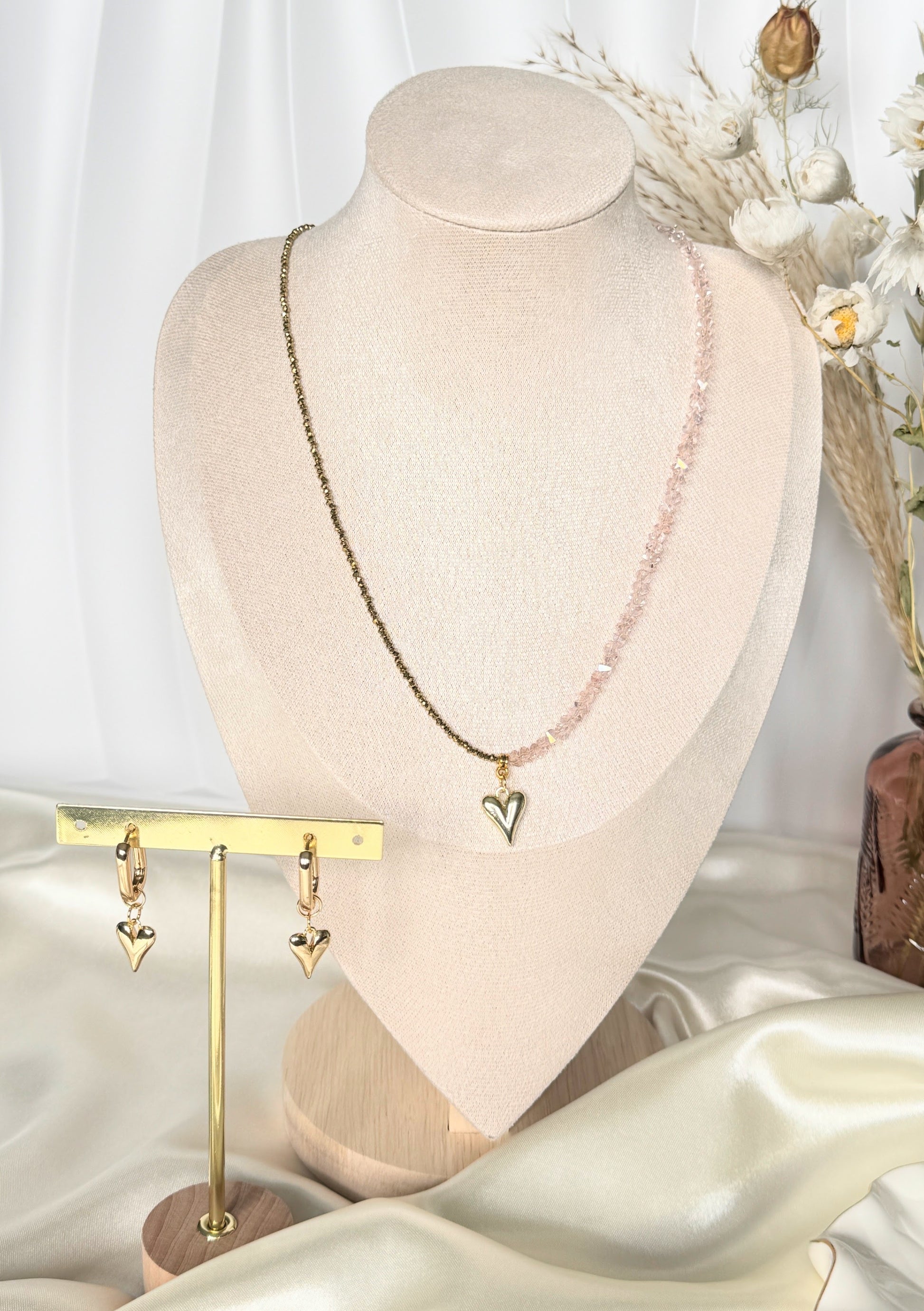 Close-up of pink gold hematite crystal necklace and earrings set