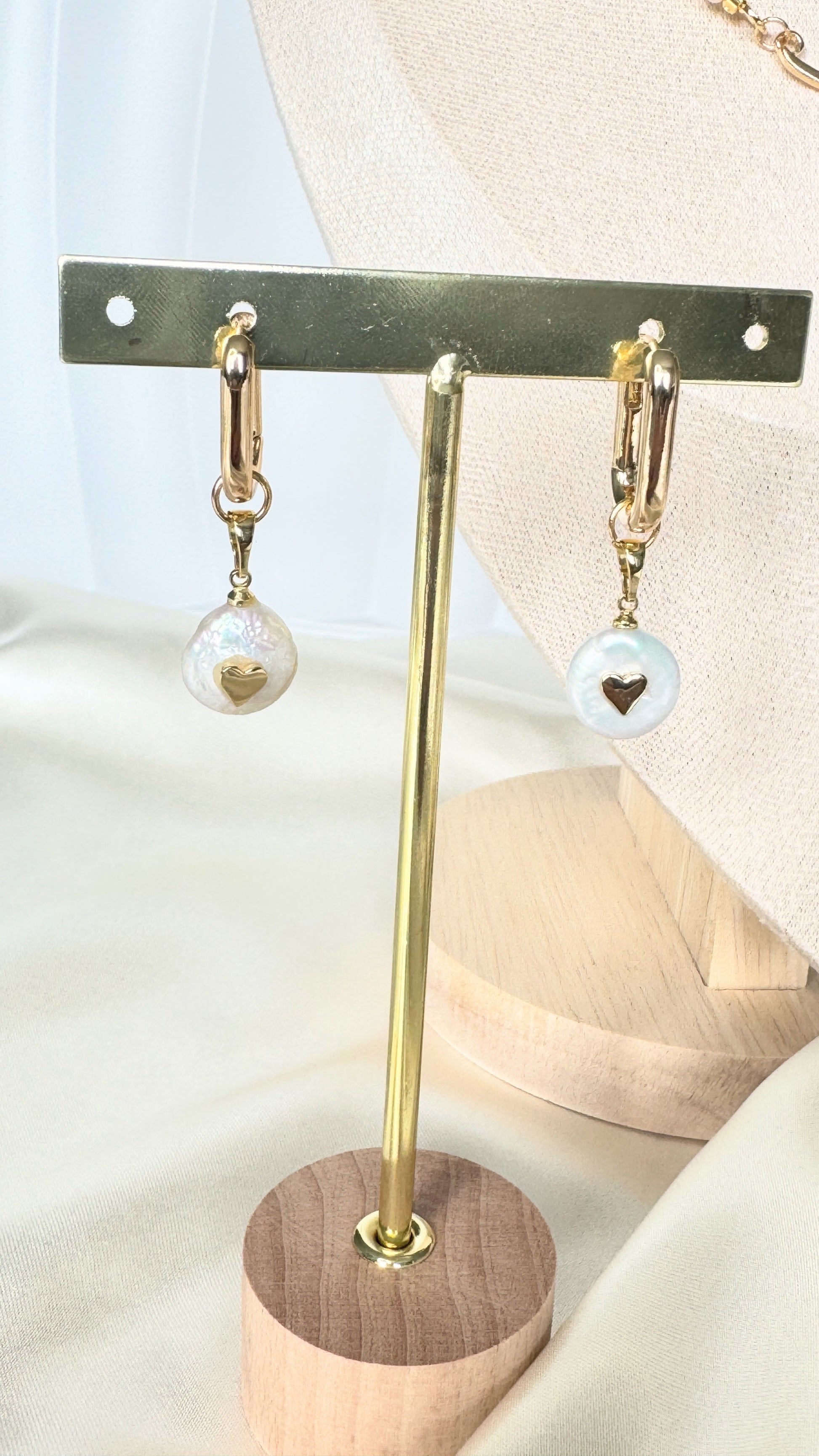 Elegant pearl earrings displayed on jewelry tray