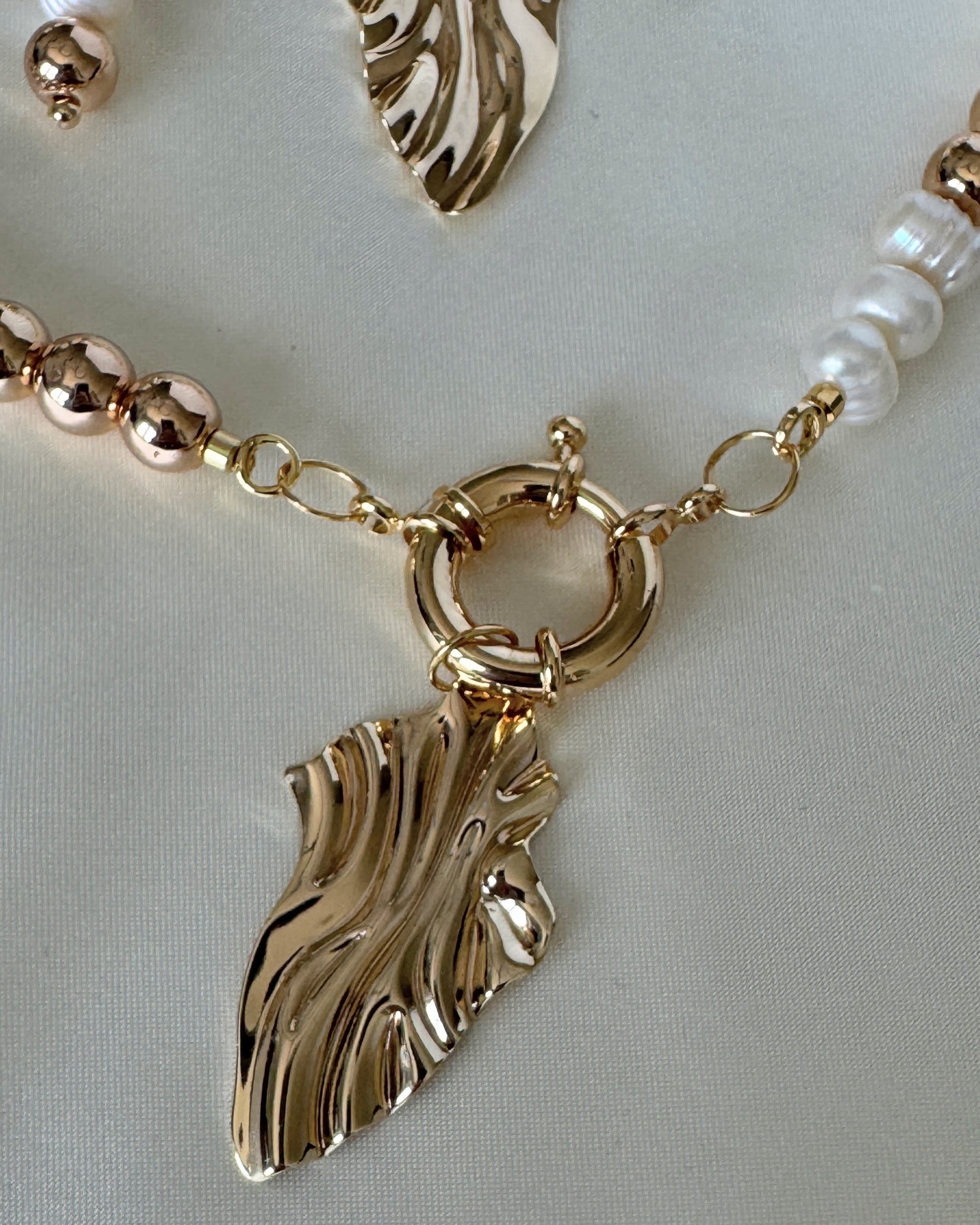 Close-up of golden hematite beads and freshwater pearls on necklace