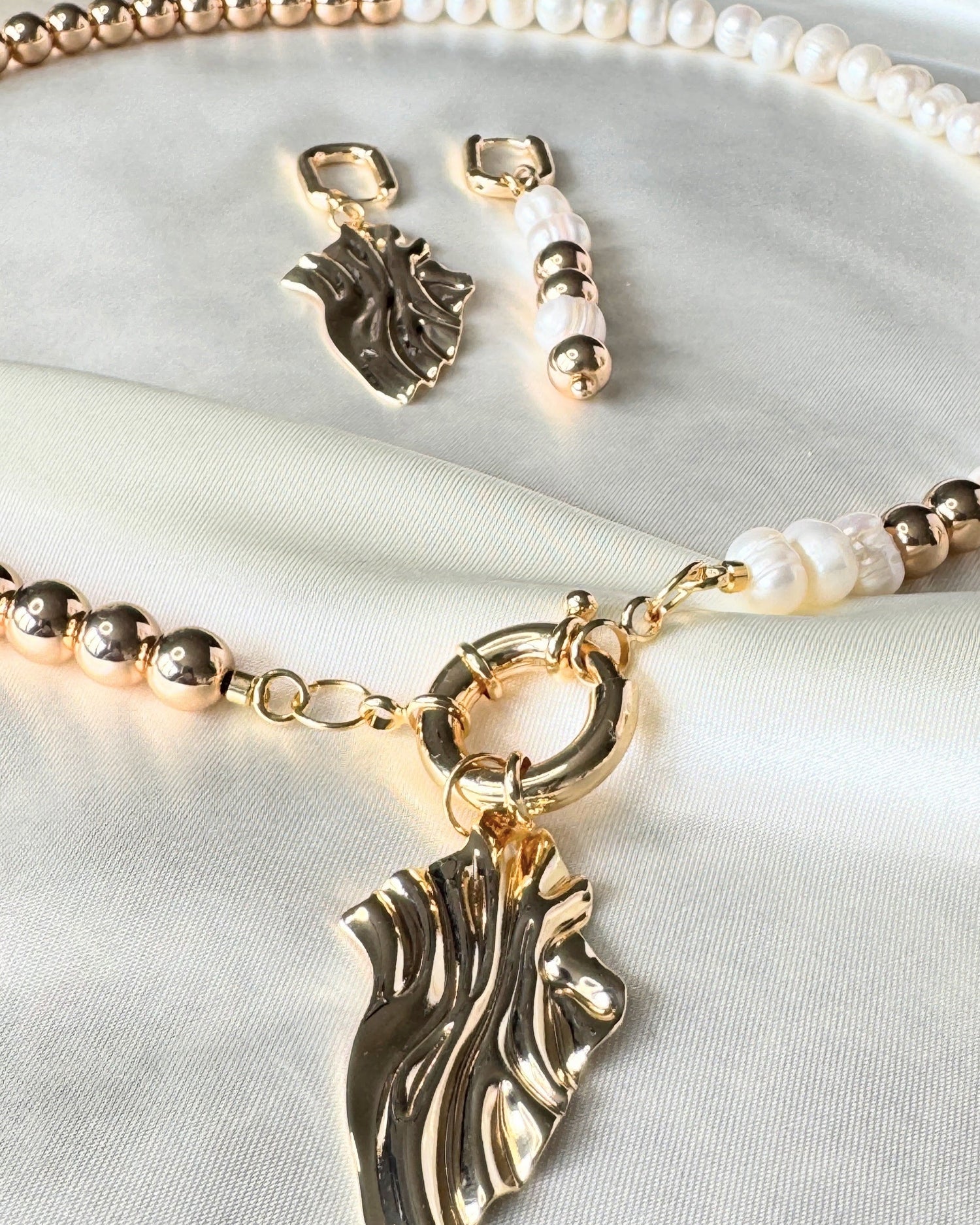 Close-up of golden hematite pearl necklace, earrings