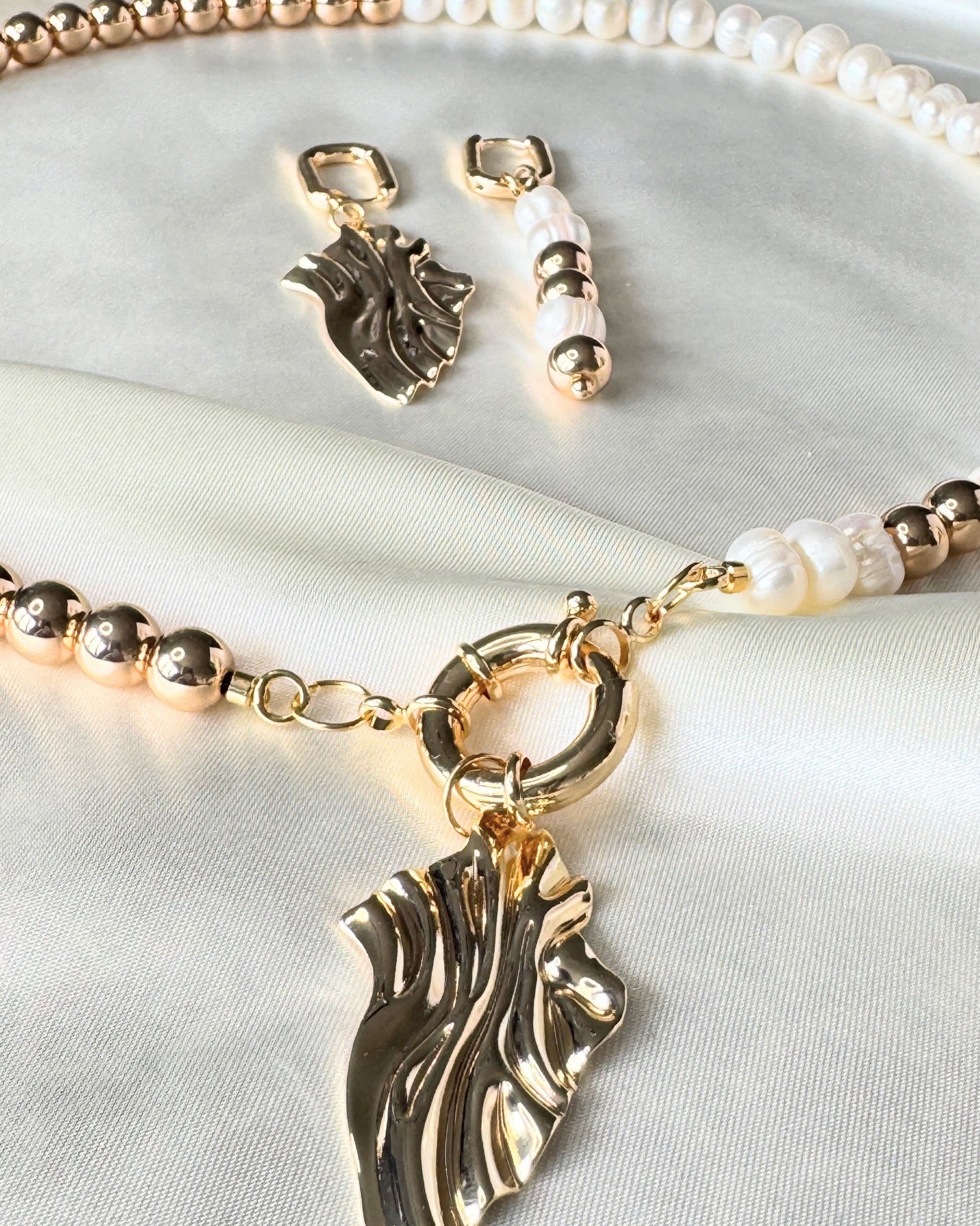 Close-up of golden hematite pearl necklace, earrings