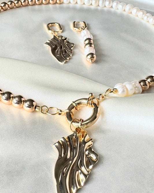 Close-up of golden hematite pearl necklace, earrings