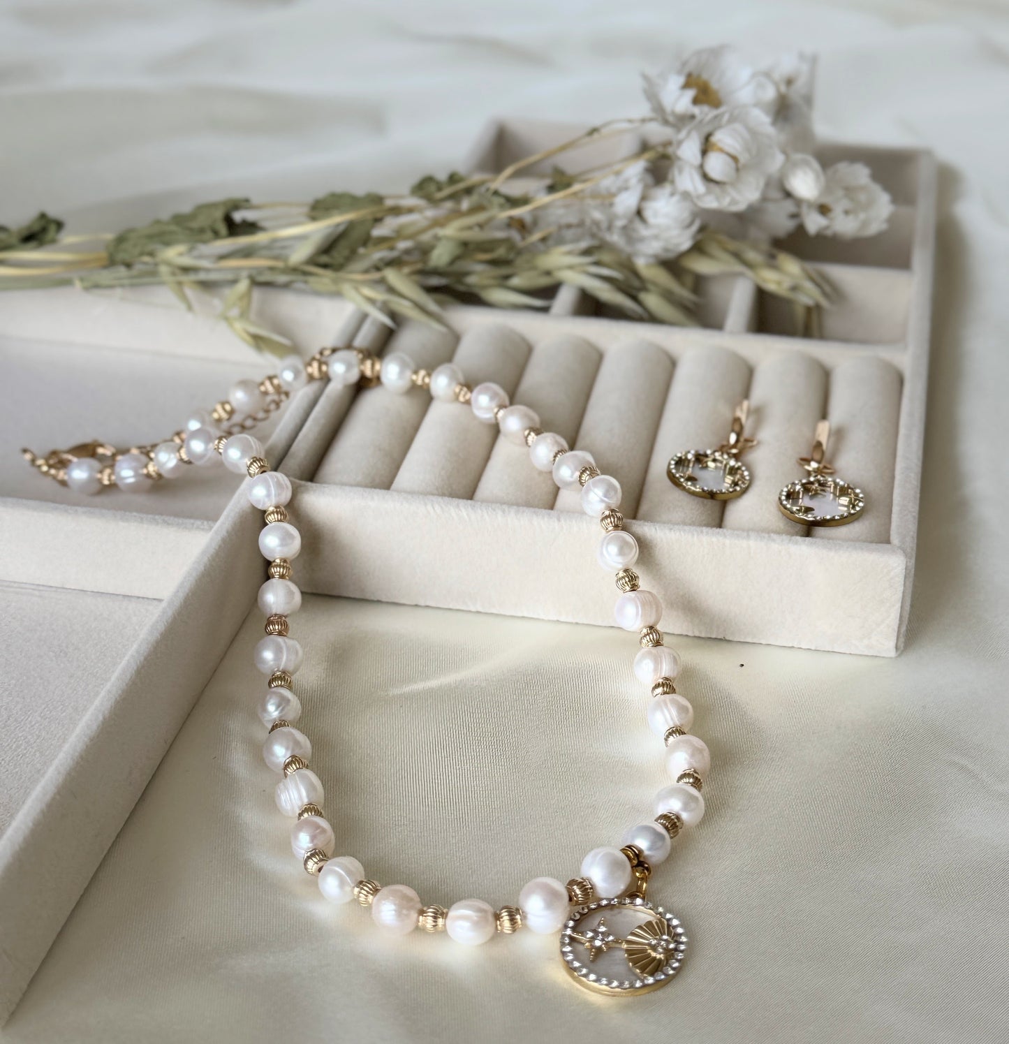 Elegant mother-of-pearl beaded necklace paired with gold shell earrings