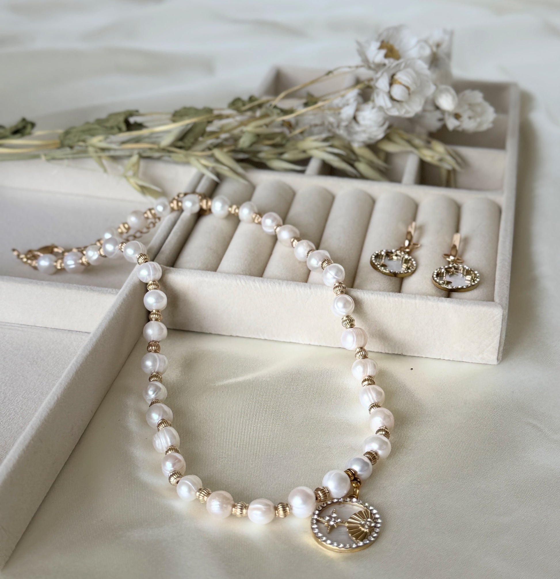 Elegant mother-of-pearl beaded necklace paired with gold shell earrings
