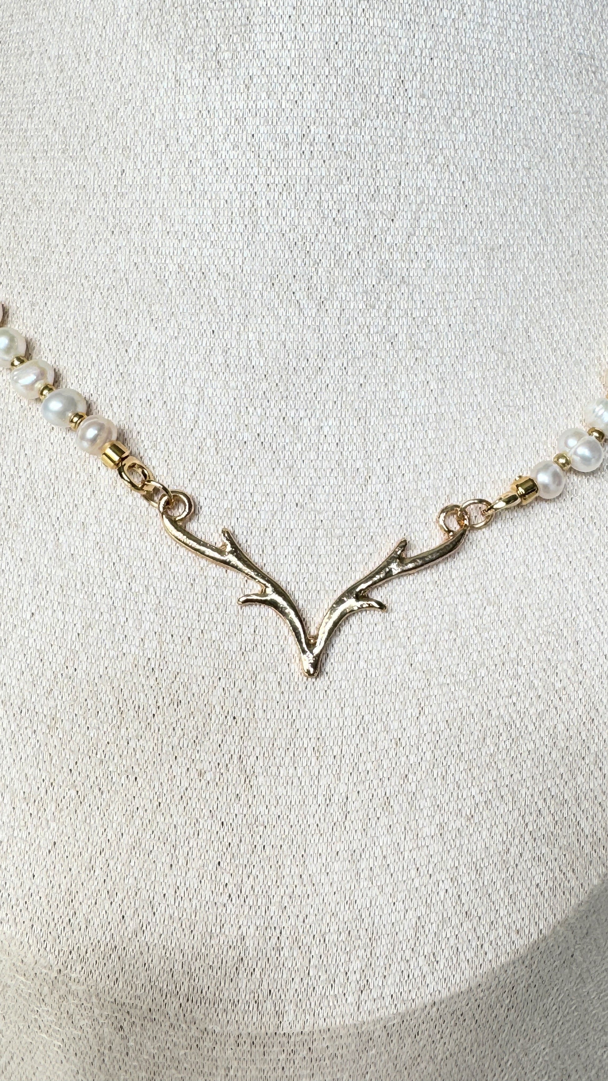 Layered pearl necklace with gold deer antler pendant