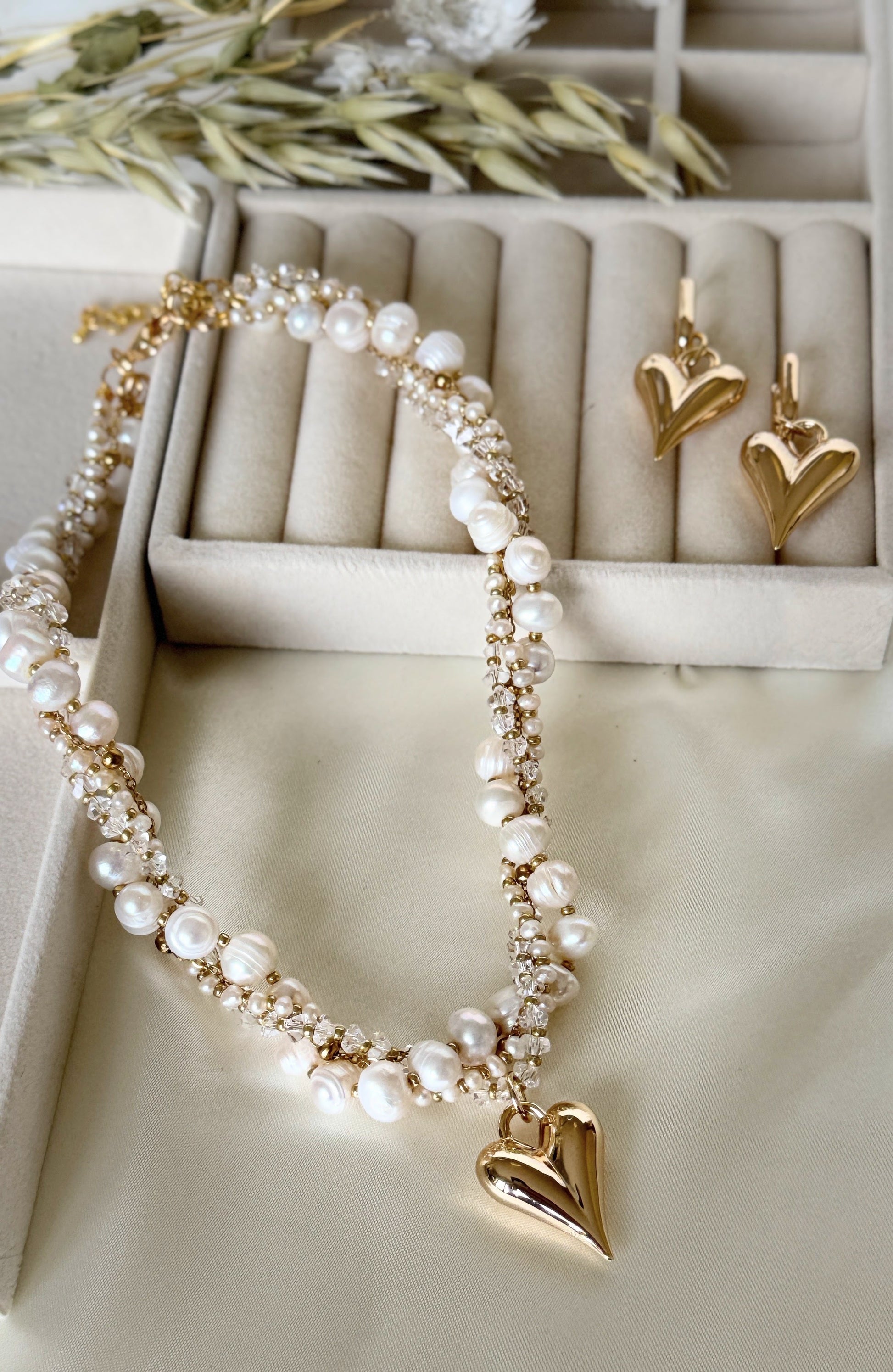 Close-up of layered pearl crystal necklace with matching earrings