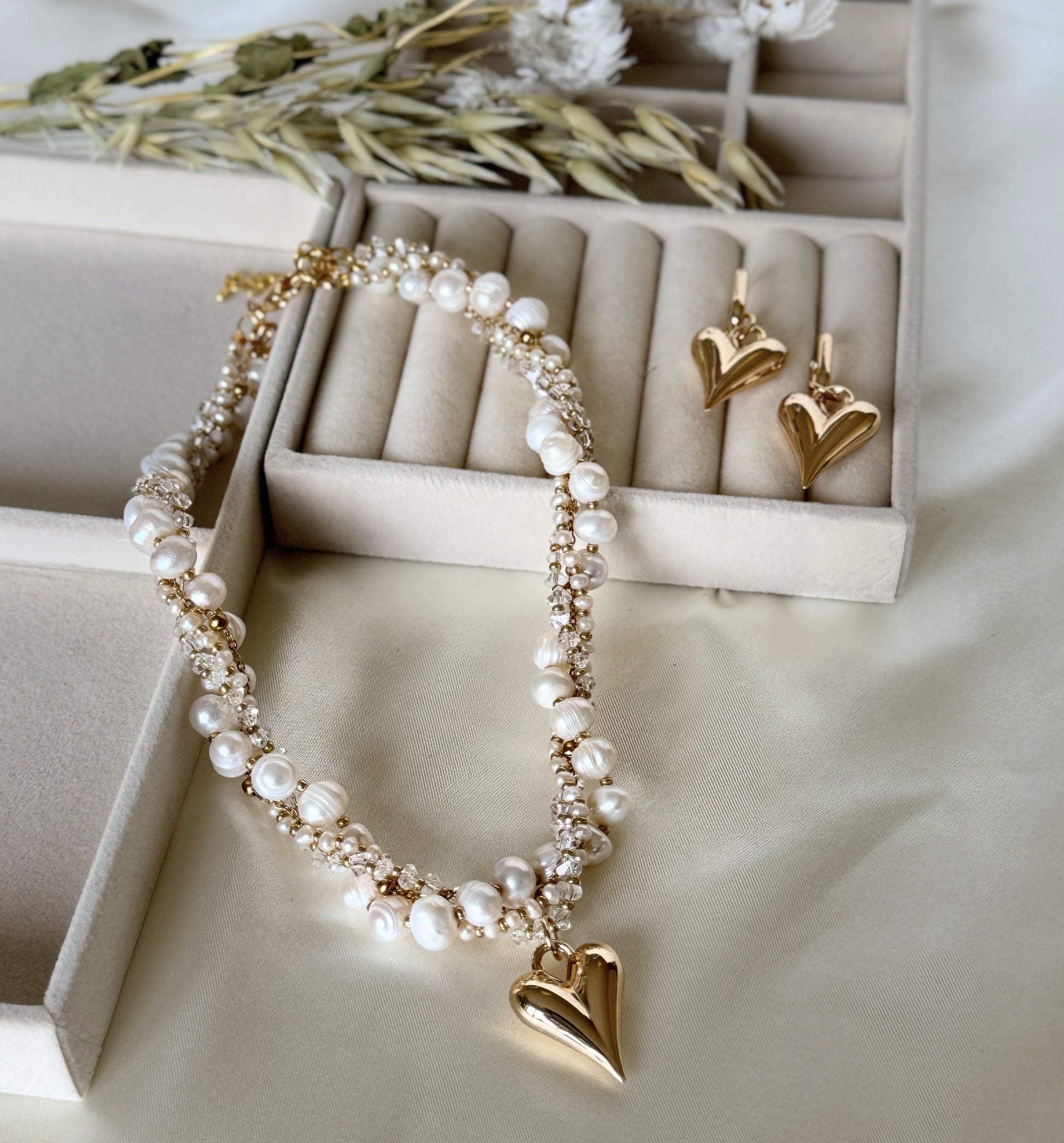 Elegant layered pearl and crystal necklace paired with earrings