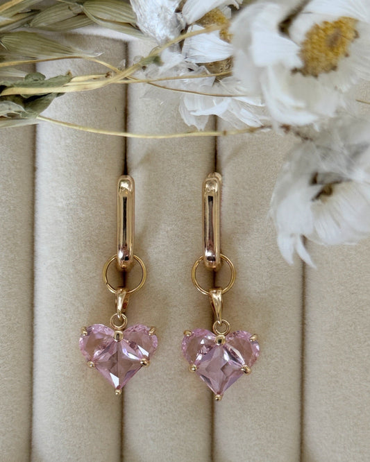 Close-up of pink crystal pearl earrings with delicate gold accents