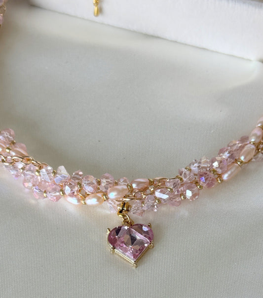 Close-up of pink crystal beads and freshwater pearls on layered necklace